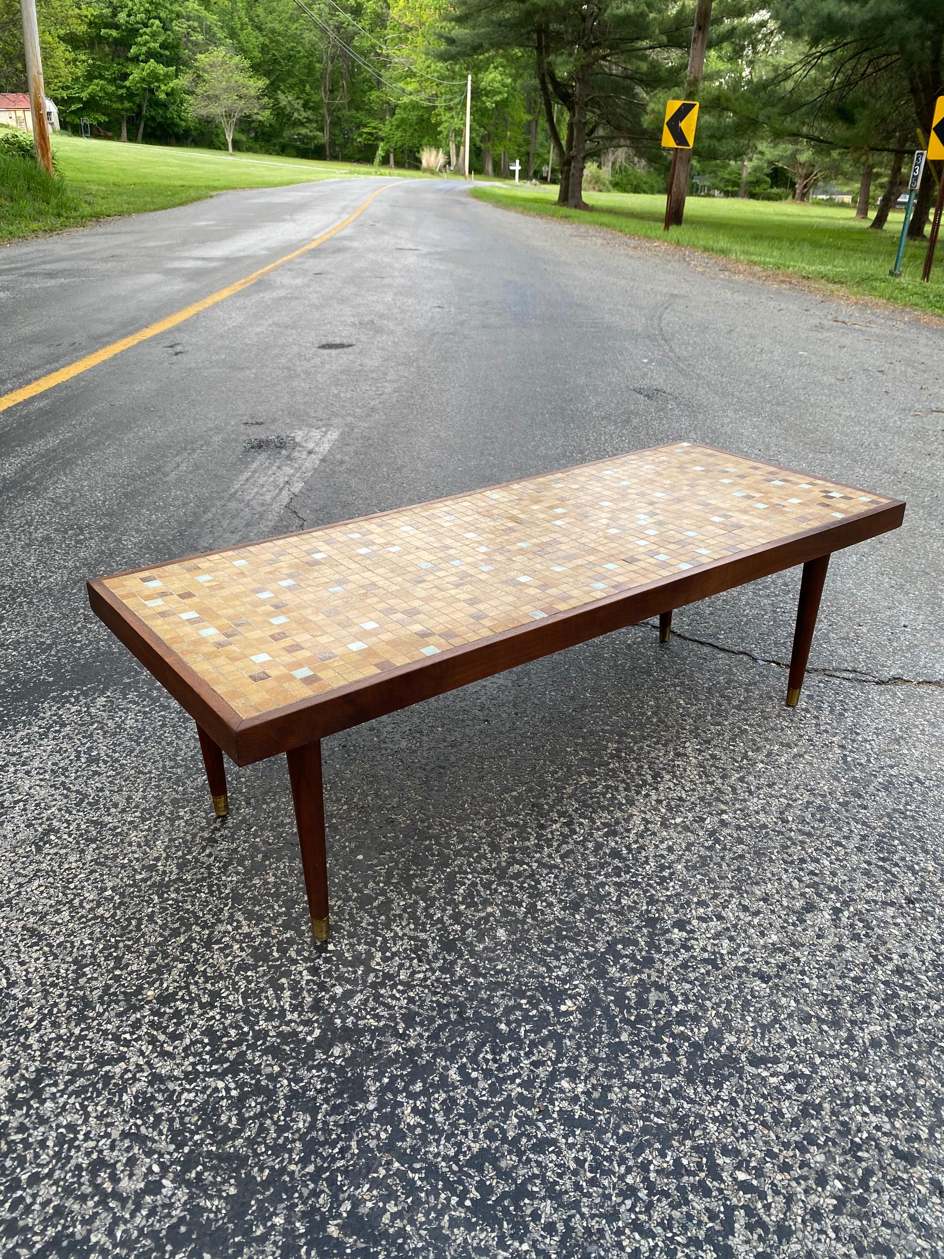 Murano glass tile rectangular coffee table in shades of tans and browns. Walnut frame and legs with brass caps.