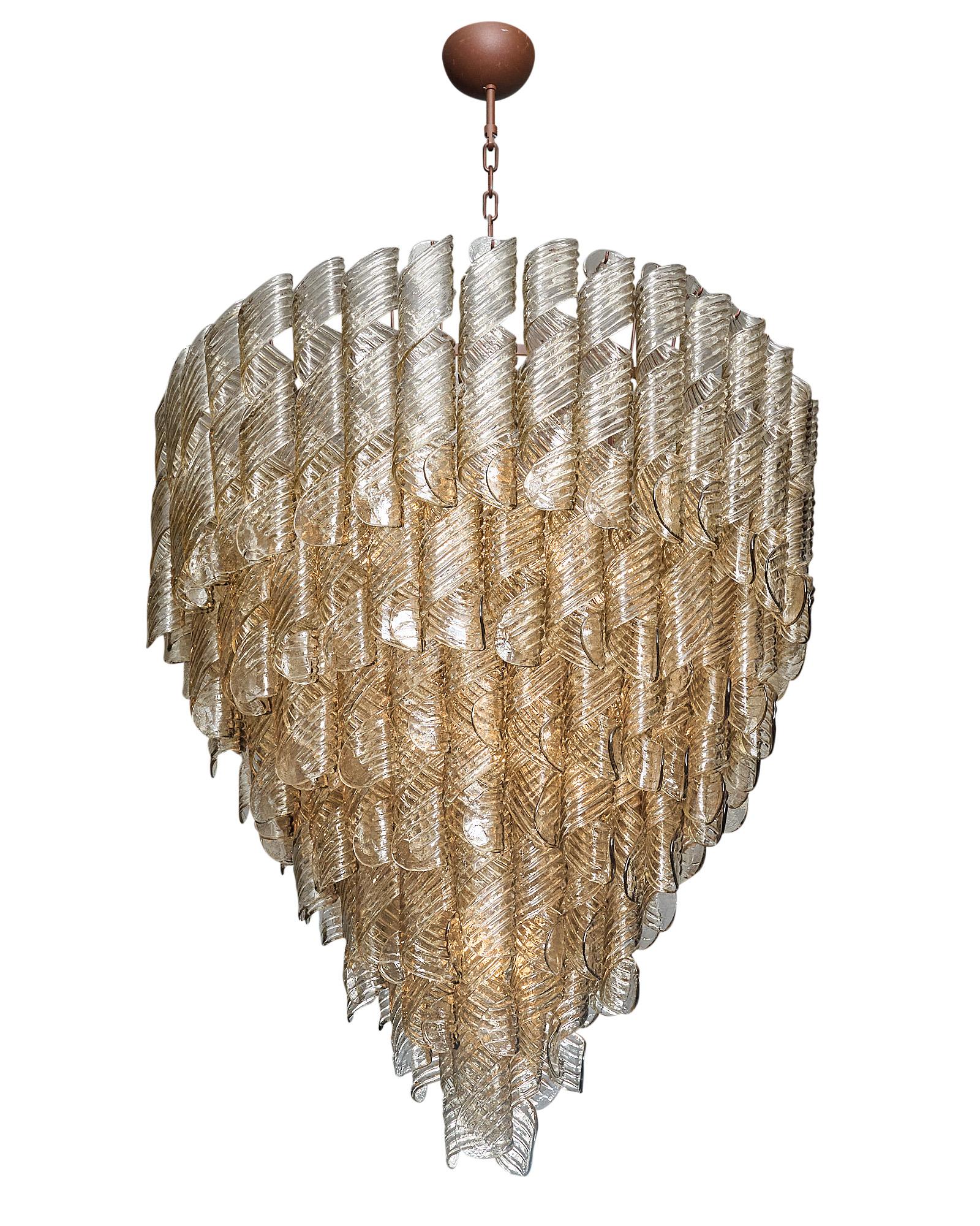 Italian Murano glass “torciglione” chandelier made with hand-blown glass elements in the “torciglione” spiraled shape. Each piece is curved and features a stamped texture on the smoked glass. This chandelier is composed of these pieces in cascading