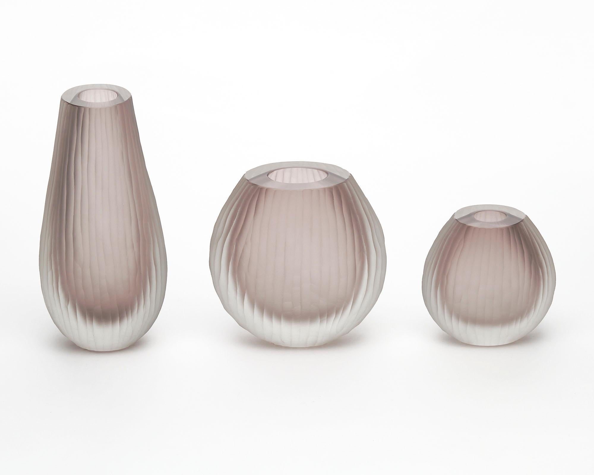 Vase trio made of hand-blown glass from the island of Murano outside of Venice, Italy. The set has been made using the “battuto” or hammered technique. They are in a lovely light amethyst colored glass. The measurements listed are for the tallest