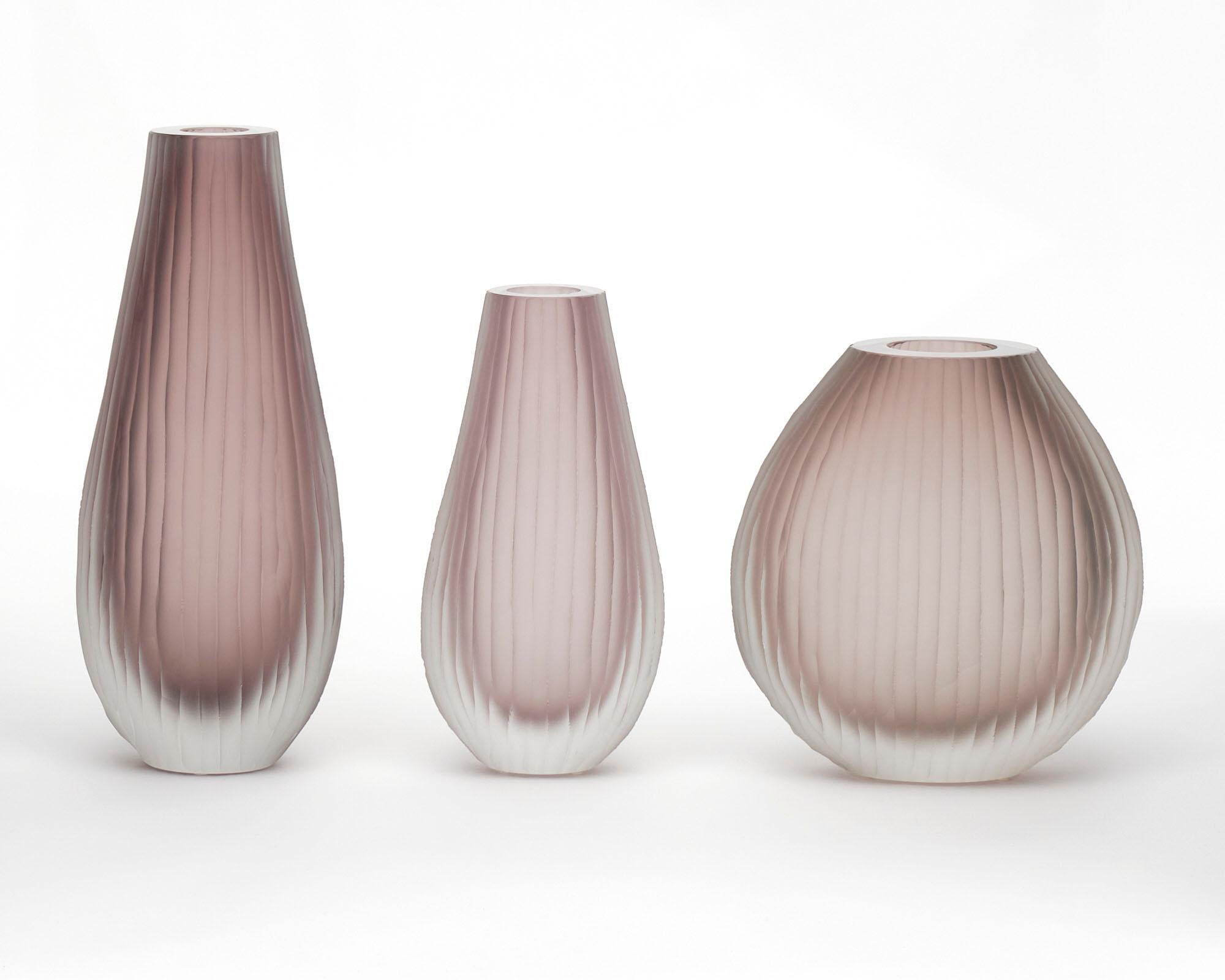 Set of three Murano glass vases in the manner of Tobia Scarpa. The set has been made using the “battuto” or hammered technique. They are in a beautiful amethyst tone. The measurements listed are for the tallest vase. The measurements for all three
