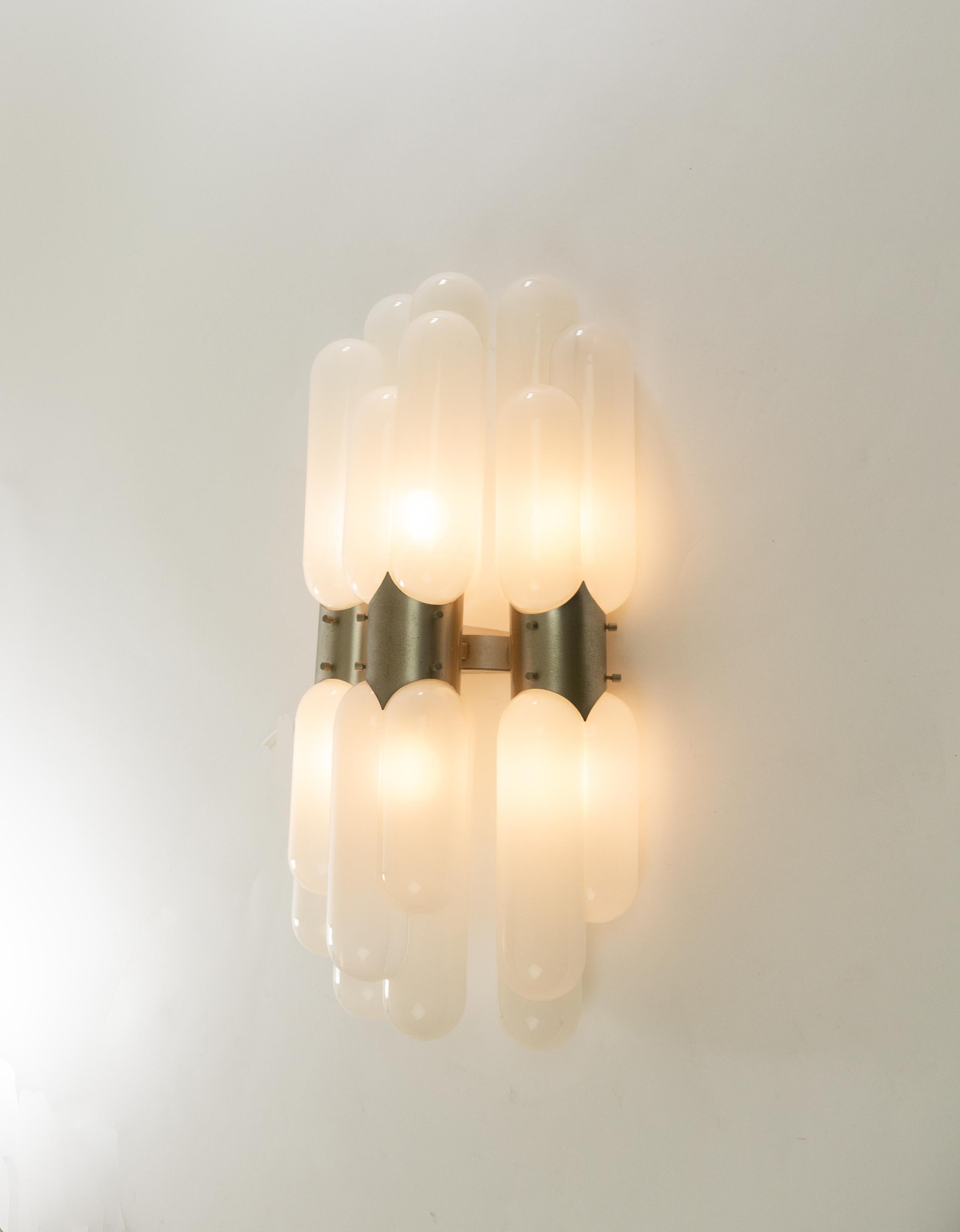Wall lamp made from hand blown Murano glass, most probably designed and produced in the 1970s.

This impressive piece with sculptural quality consists of six identical glass tubular elements, each consisting of three parts of different sizes. The