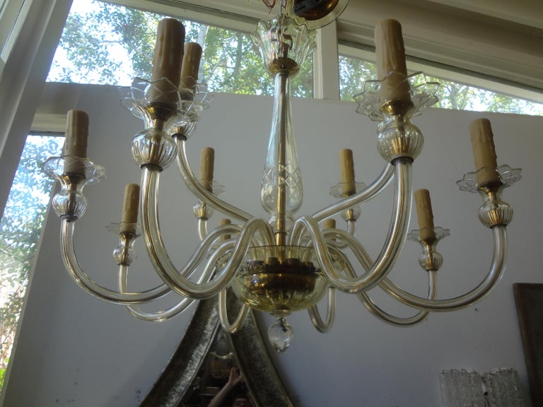 Murano glass two tiered chandelier by Seguso. This stunning Murano glass chandelier is executed in a very light gold color. There are 4 lights on the upper level
And 8 lights on the lower level. This chandelier has been newly wired for the U.S.