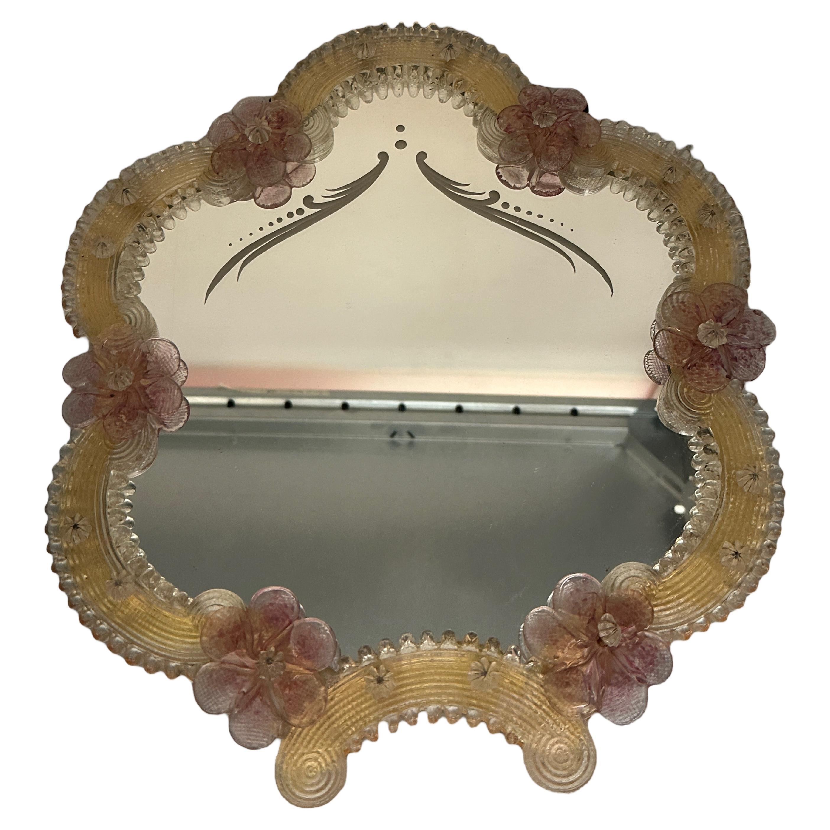 A gorgeous Murano glass vanity mirror surrounded with handmade pink glass flowers. Beautiful wall mirror. With minor signs of wear as expected with age and use. A nice addition to any girls or ladies room. Its stands about 1 1/4