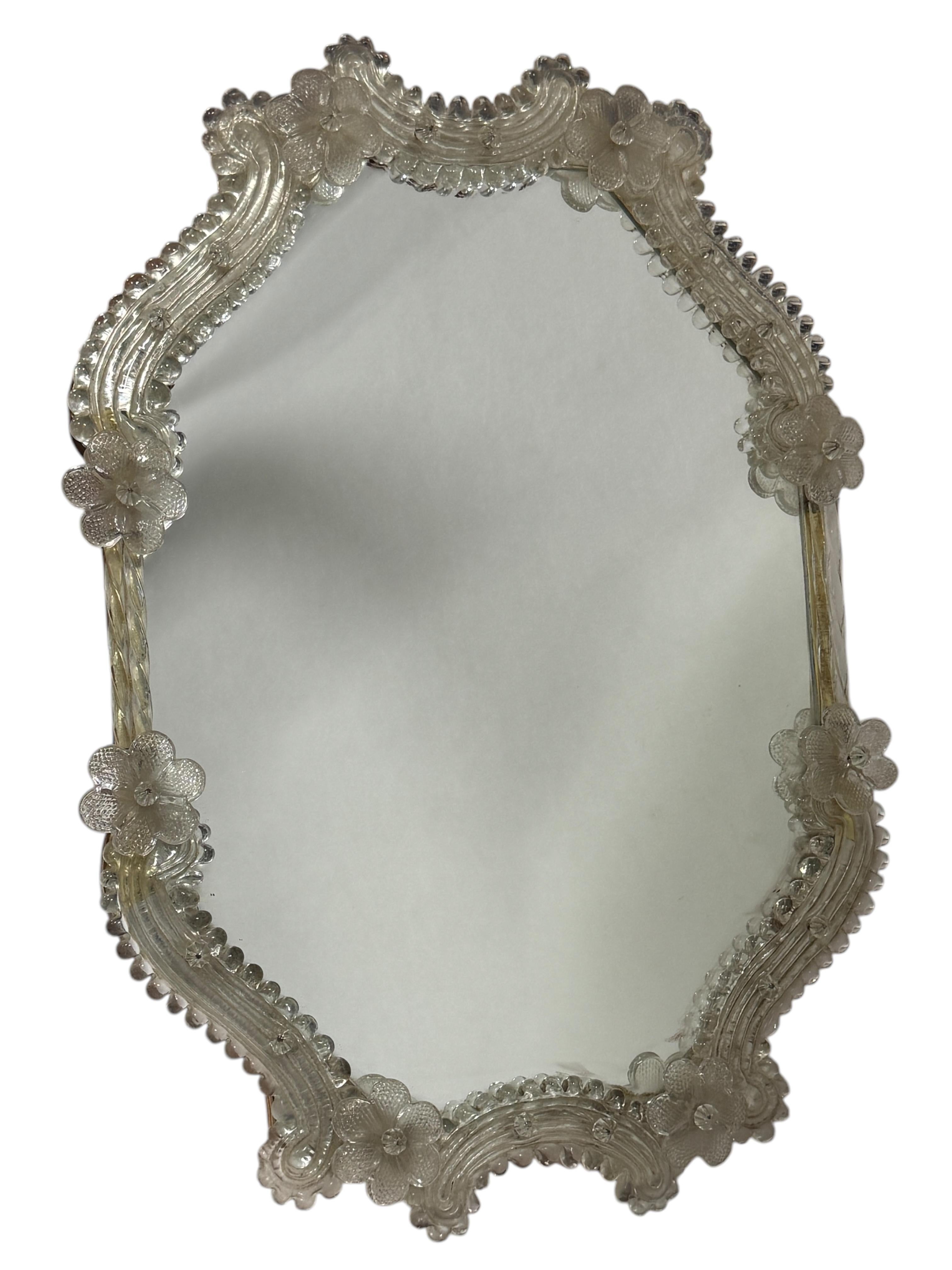 A gorgeous Murano glass vanity mirror surrounded with handmade clear flowers. Can be used as a table or a wall mirror (has no hook yet but if you attach one it will fit perfect at a wall). With minor signs of wear as expected with age and use. A