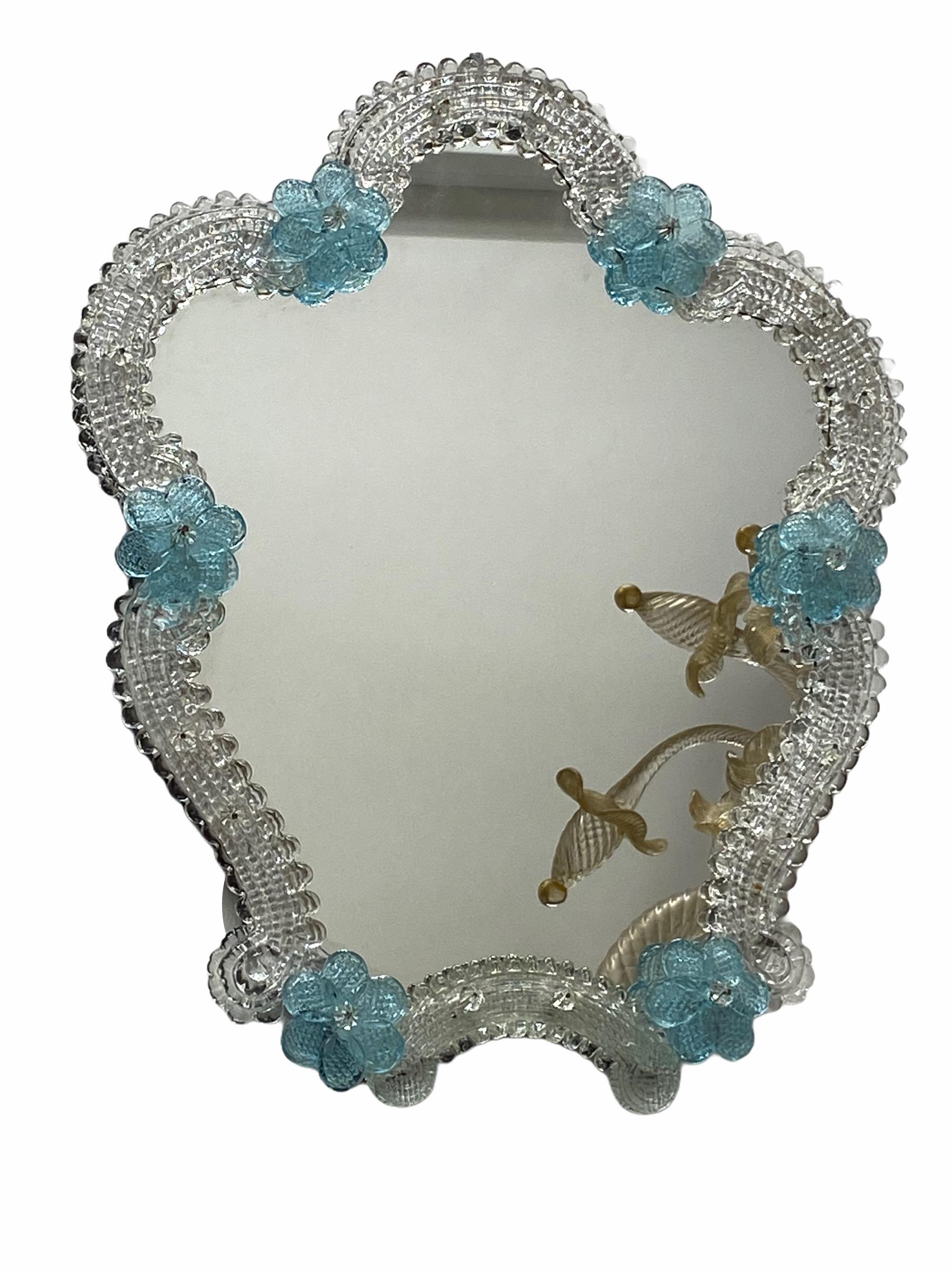 A gorgeous Murano glass vanity mirror surrounded with handmade light blue flowers. With minor signs of wear as expected with age and use. A nice addition to any dressing room.
