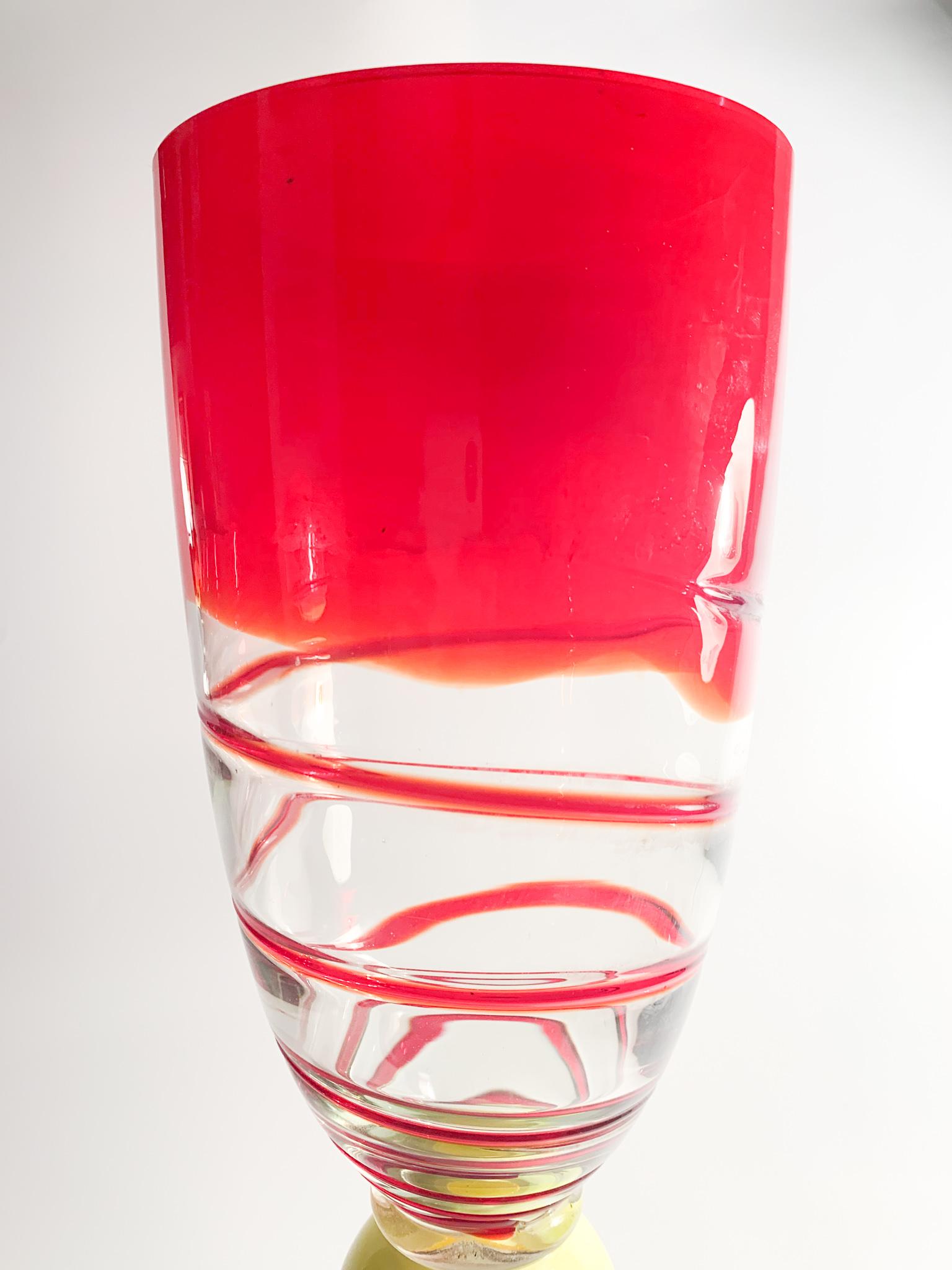 Vase in red, yellow and blue Murano glass, whose creation is attributable to Carlo Moretti in the 1960s

Measures: Ø cm 14 H cm 41

The vase is not signed, however the shape and the use of colours are attributable to Carlo Moretti