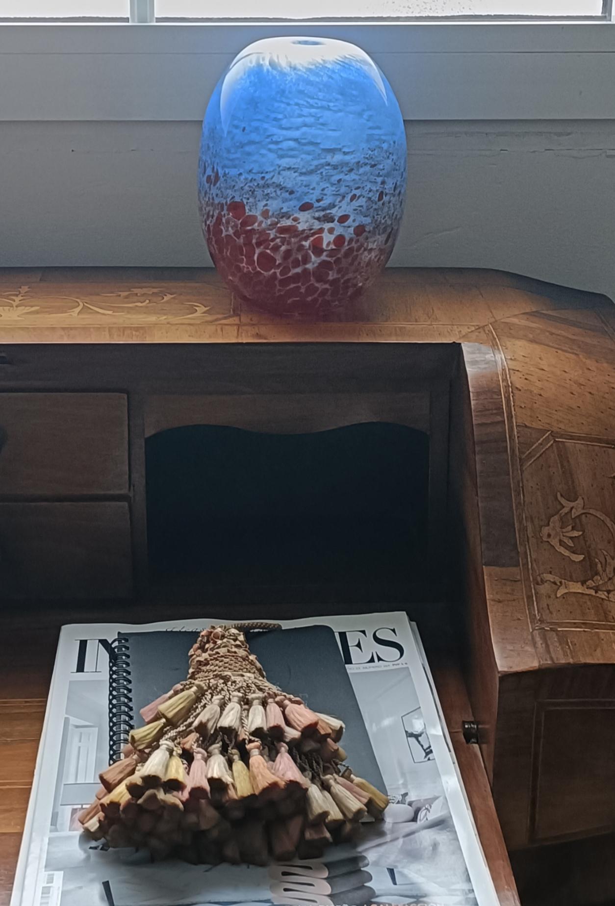 Murano glass vase attributed to Venice glass artist Anzolo Fuga for A.Ve.M. Handcrafted in the Murano island near Venice, Italy, circa the 1950s.

It is spectacular in the hand - the way the glass is worked along the ovoid shape blending the red
