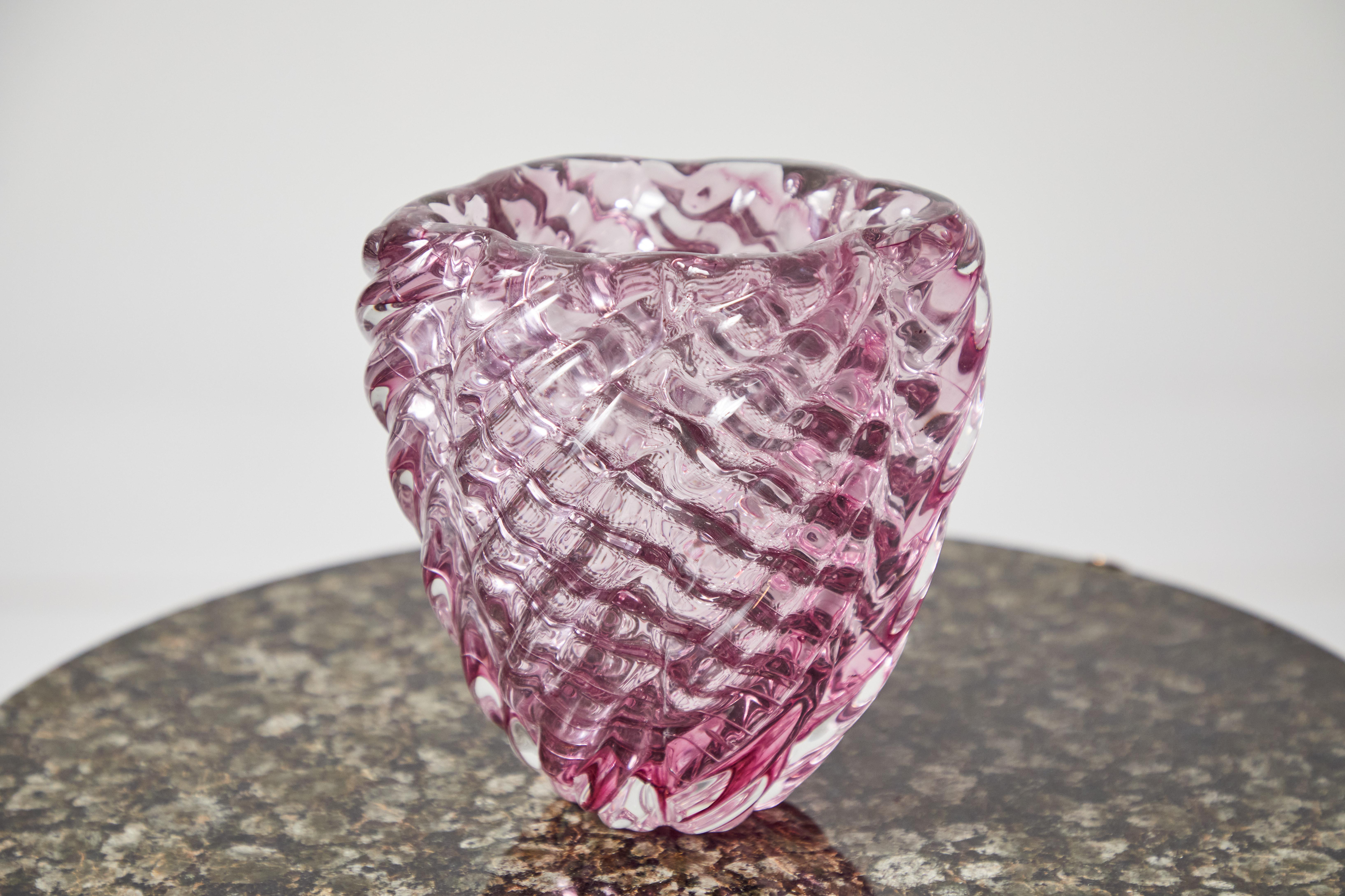 This elegant Venini Murano vase is a classic rose pink. Diagonally ribbed, both inside and out, the glass creates a basket weave like pattern. The visible 4 line acid stamp reads 