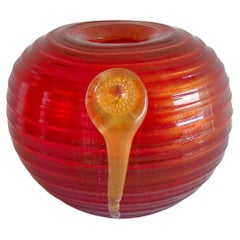Murano glass vase in vibrant red adorned by a central gold pendant Italy 1980s