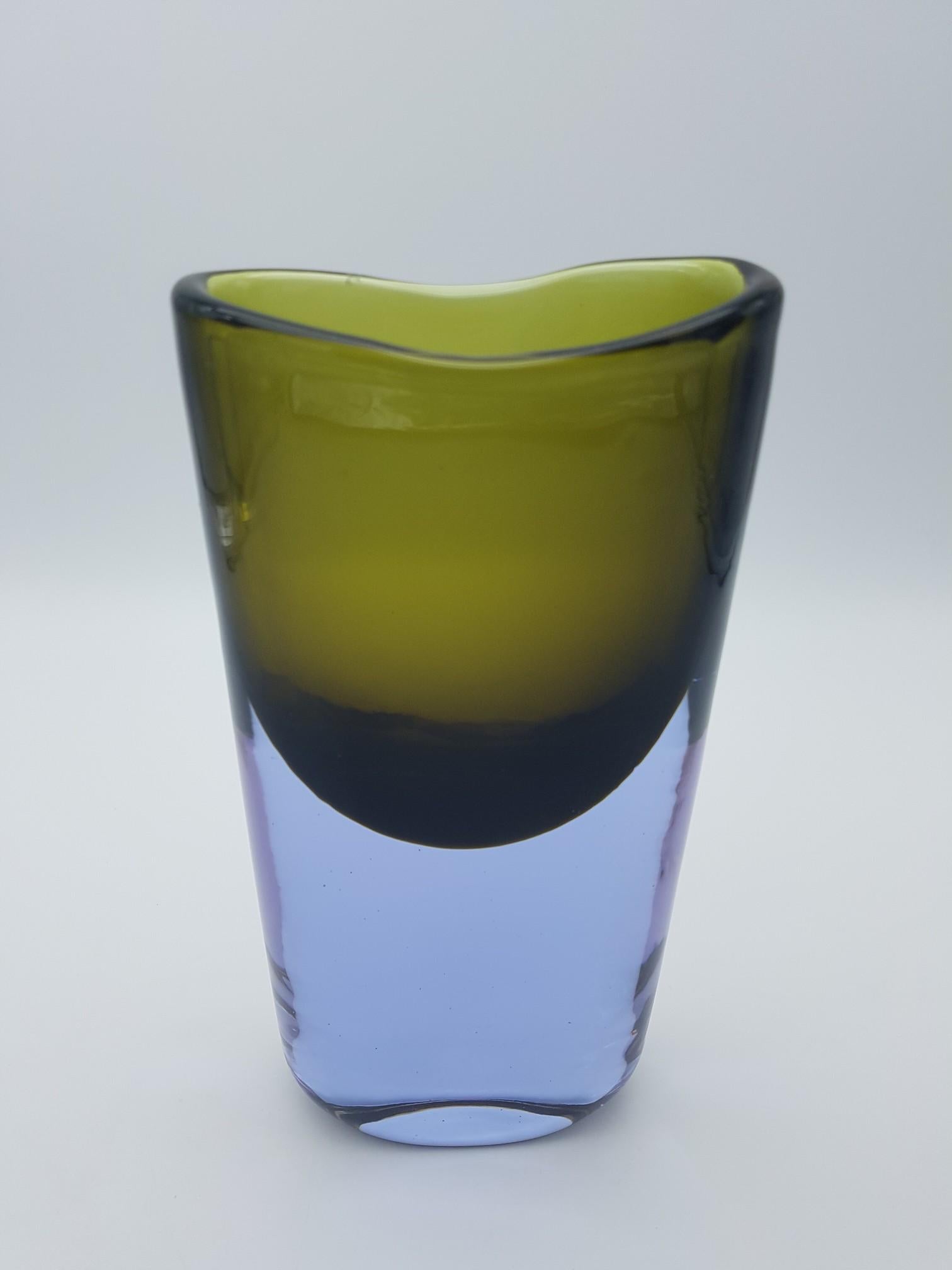 This modern and elegant Murano glass vase has been handmade by the Gino Cenedese e Figlio glass-factory in the mid-1960s, design by Antonio da Ros. The vase has an oval cross-section and features lavender and military green colors, he lavender color