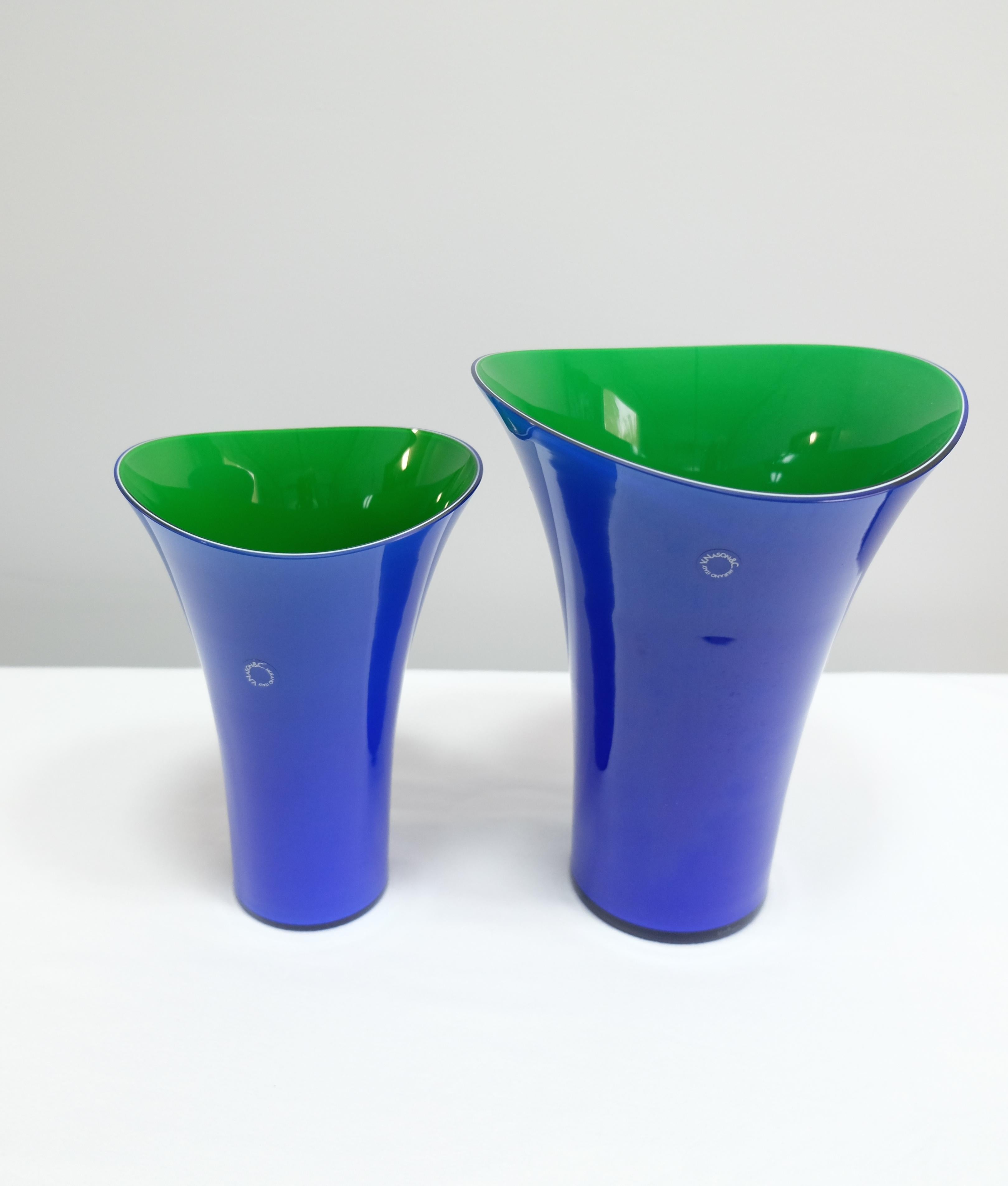 Offered for sale is a striking pair of hand blown asymmetrical vases in blue and green by V. Nason & C. The vases retain the original maker's label. Vincenzo Nason established his glassworks, Vincenzo Nason & Cie (VNC) on the island of Murano,