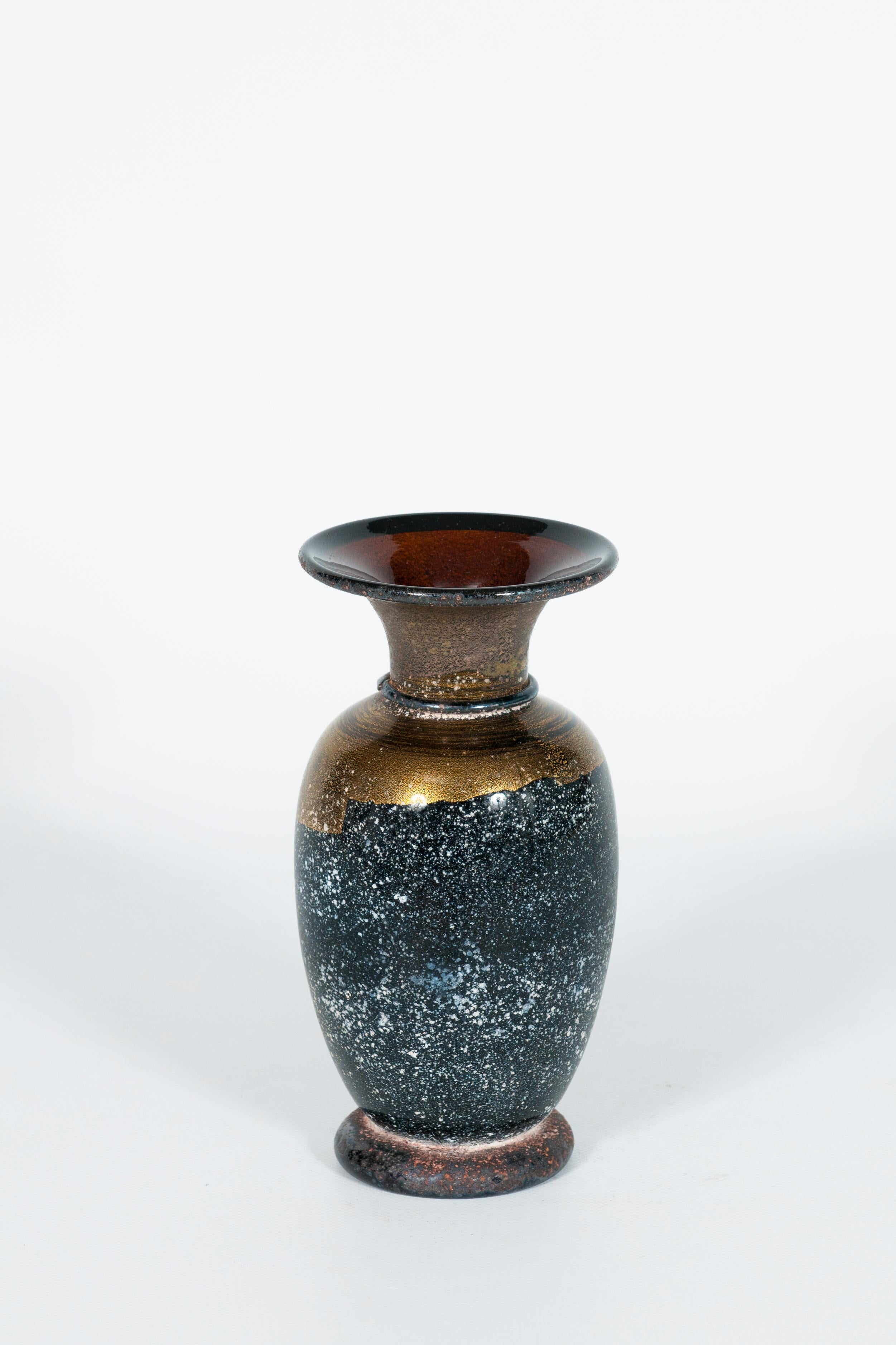 A sophisticated and striking piece of mid-to-late 20th-century decorative art, this hand-blown Murano glass vase embodies the refined craftsmanship and innovative techniques of the renowned Venetian glass masters.

This elegant vase features a
