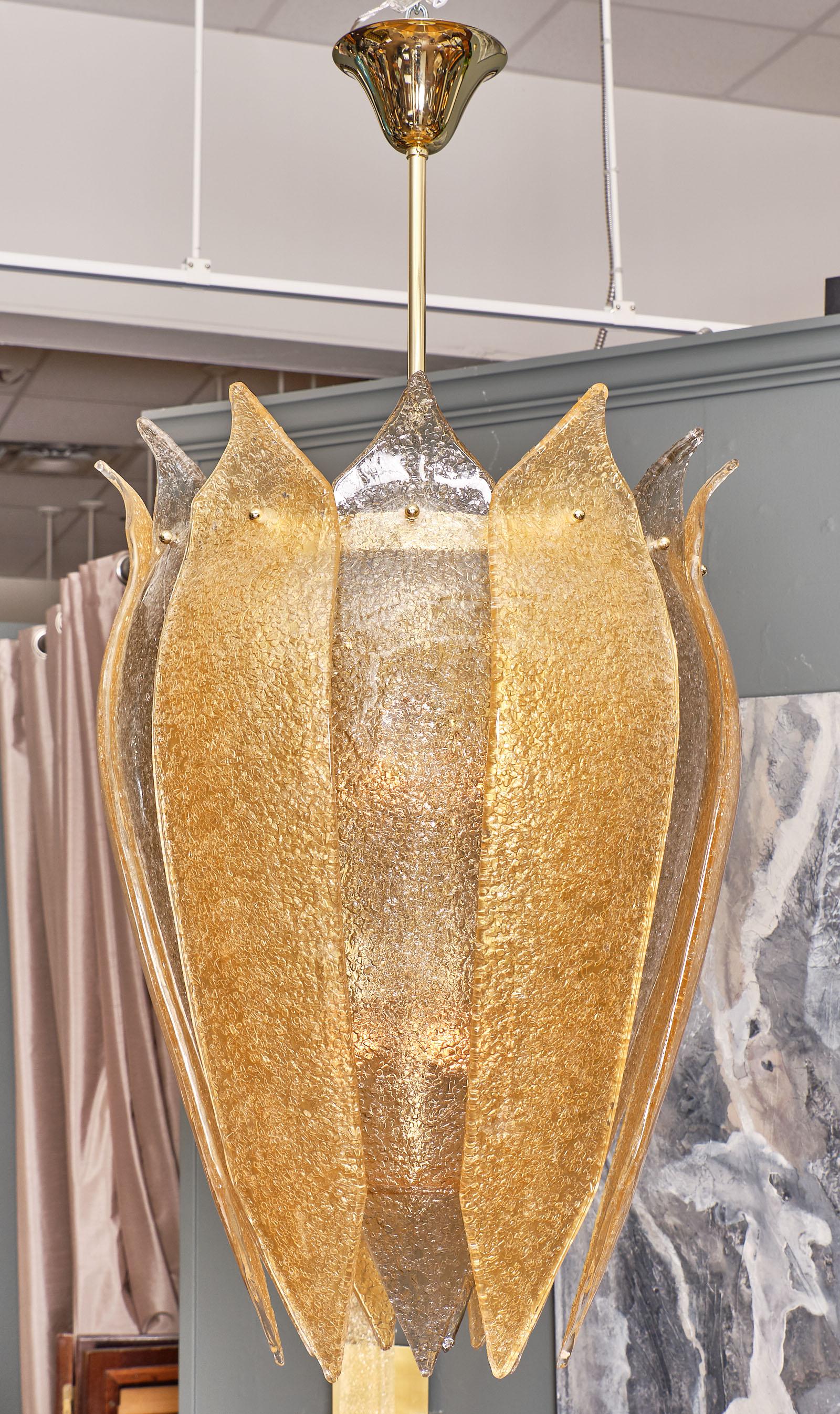 Murano glass “Virna” lantern chandelier with a spectacular curved form and “graniglia” hand blown glass leaves in gold and amber. The structure is brass. This piece has been newly wired to fit US standards.