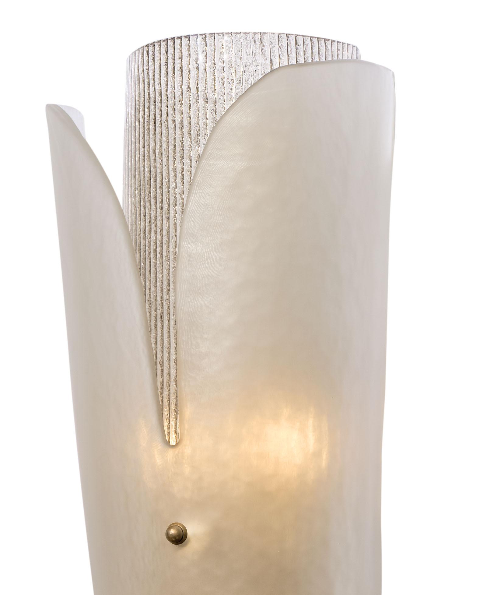 Murano glass wall sconces from the island of Murano in Italy. This hand blown pair has beautiful layers of textured glass mounted on a brass structure. The top layer has gentle curves for an elegant appearance. They have been newly wired to fit US