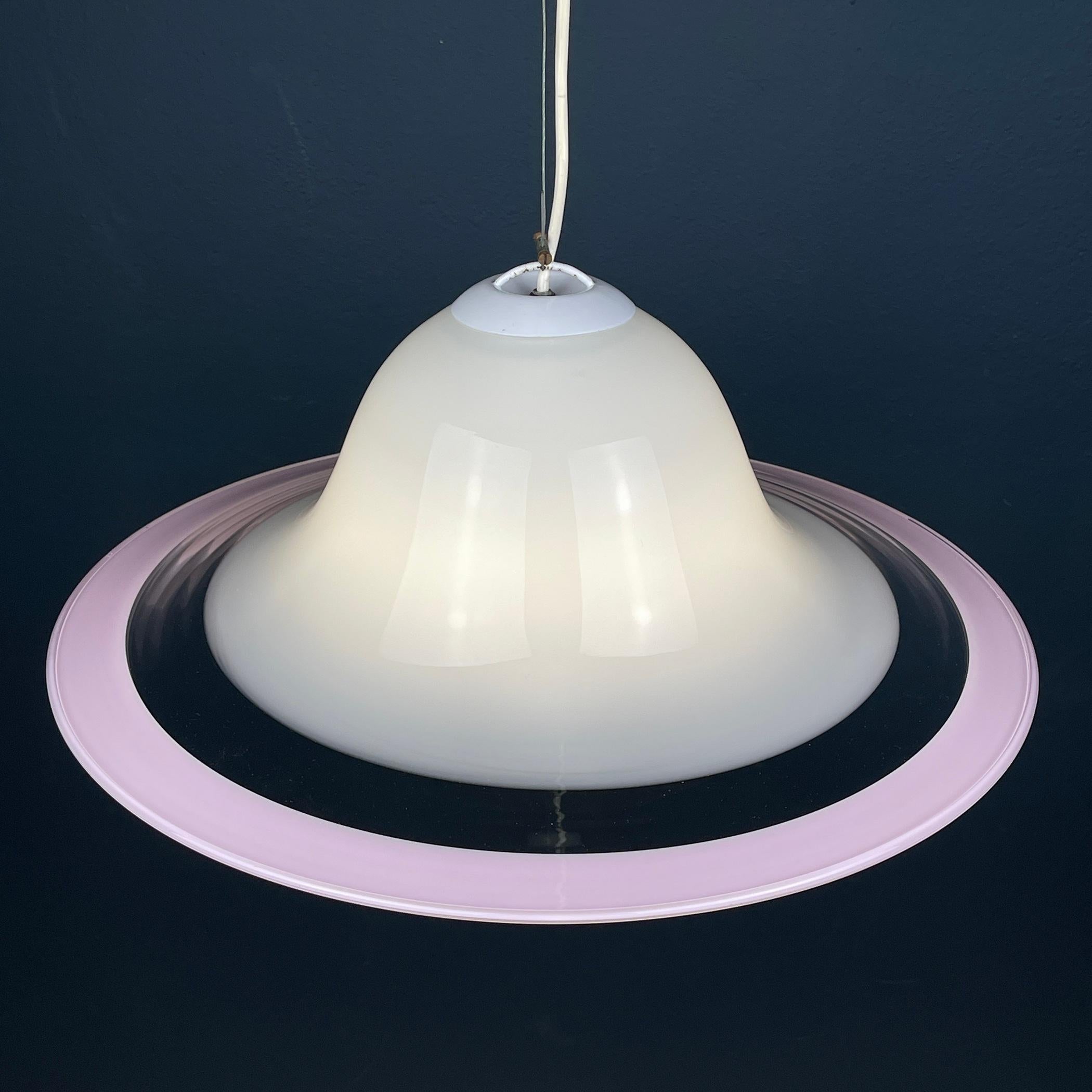 Presenting this stylish and elegant pendant lamp, a classic exemplar of 1970s Italian lighting, crafted from milky white and pink Murano glass in Italy. In excellent vintage condition, this pendant lamp exudes timeless charm and sophistication. With