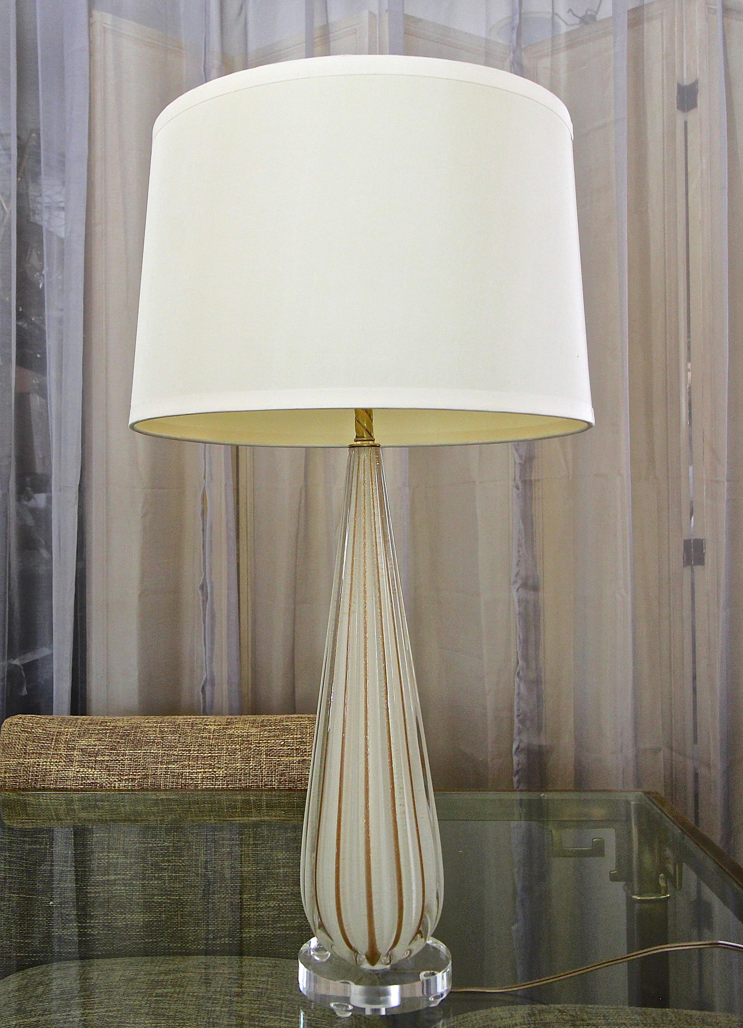 Single Murano Italian hand blown white colored glass table lamp with vertically ribbed aventurine stripes (copper colored gold) on acrylic base. Rewired with new 3-way brass socket and cord. Size of glass portion 18