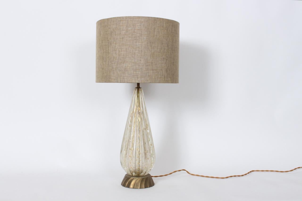 Italian Modern Murano Glass Table Lamp with Gold rimmed bubbles, 1950's.  Featuring a slender, hand blown, vertically and deeply ribbed translucent and White tear drop form with gold trimmed controlled oval bubbles and gold dust atop a patinated
