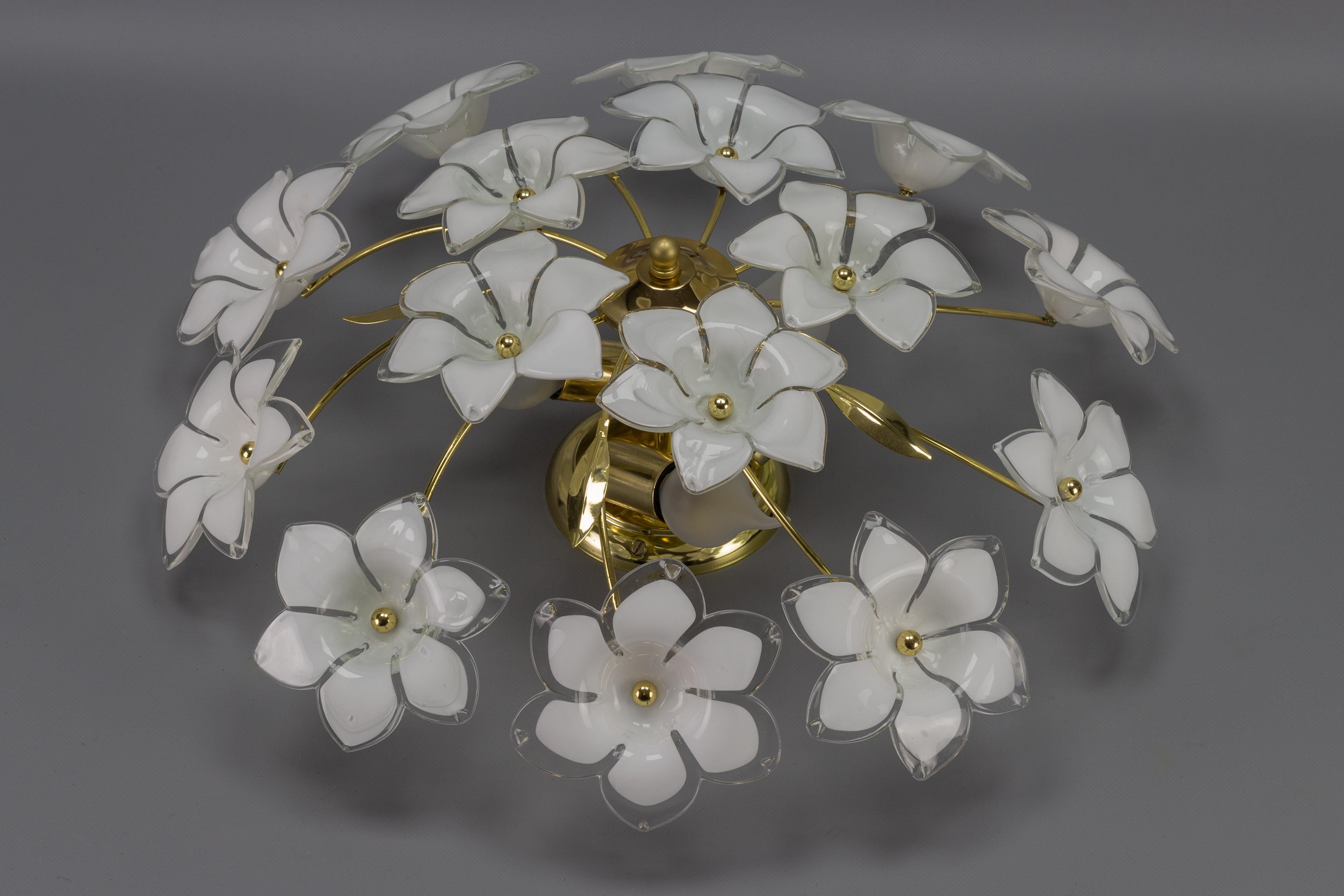 Adorable three-light ceiling light or chandelier with fifteen white and transparent glass flowers. Each beautiful Murano glass flower is hand blown and therefore all fifteen are slightly different.
Three sockets for E14 size light