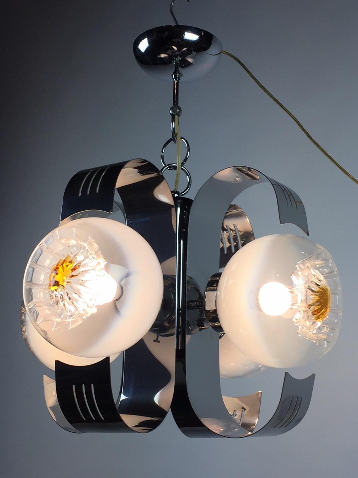 1970s modern chandelier - Pendant - Hanging lamp - Ceiling lamp - Space Age lighting
designed by Angelo Vittorio - Italy - Italian design.
Bended chrome armature with 4 hand blown Murano art glass globes with orange centres like flowers.
This