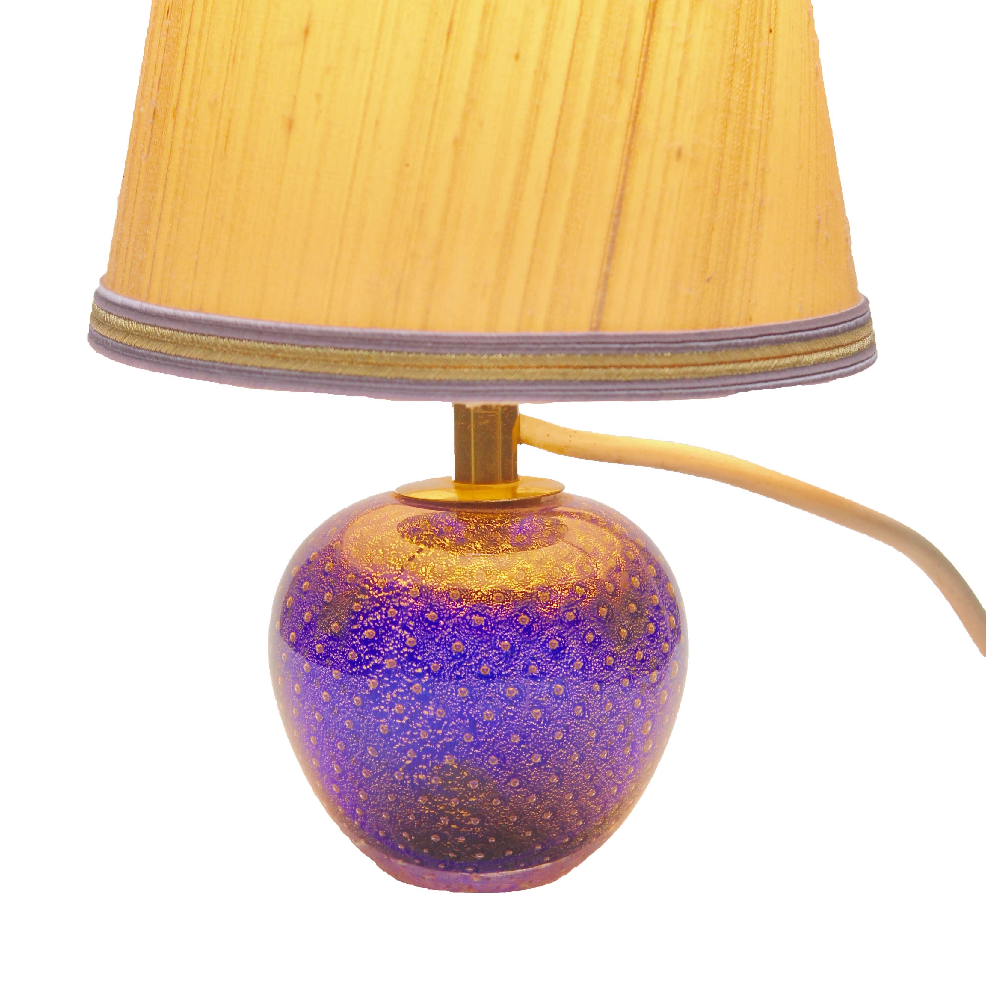 Vintage Murano globe-shaped lamp made in cobalt blue with aventurine (gold metal) and bullicante decor (finely controlled bubbles). Ideal for a bedside or side table, when lit it gives a dramatic jewel-like effect This solid lamp base, complete with