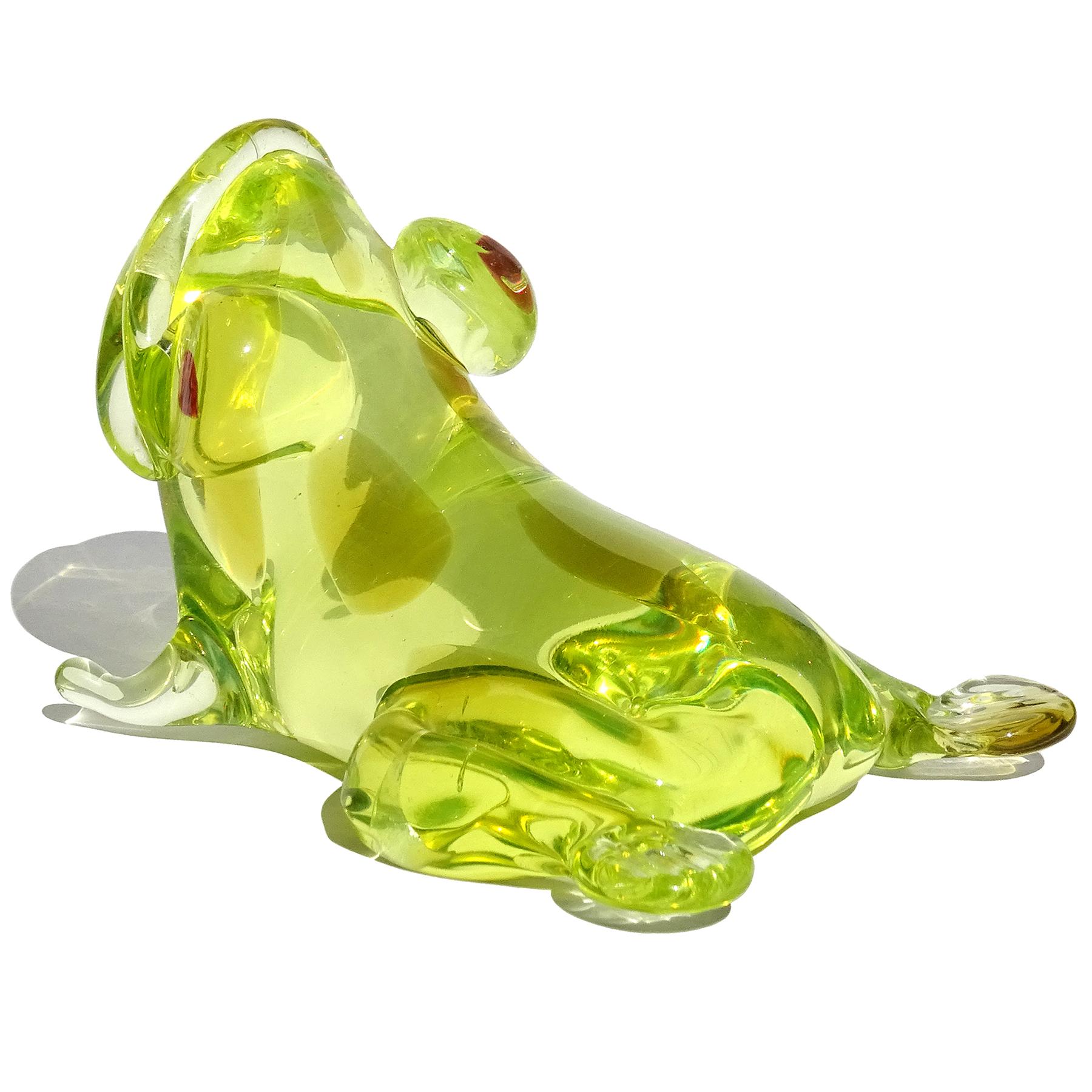 Beautiful vintage Murano hand blown glowing green with olive spots Italian art glass frog sculpture, paperweight. or figurine. Created in the manner of the Salviati company. The piece glows bright neon green under a black light from the high amount