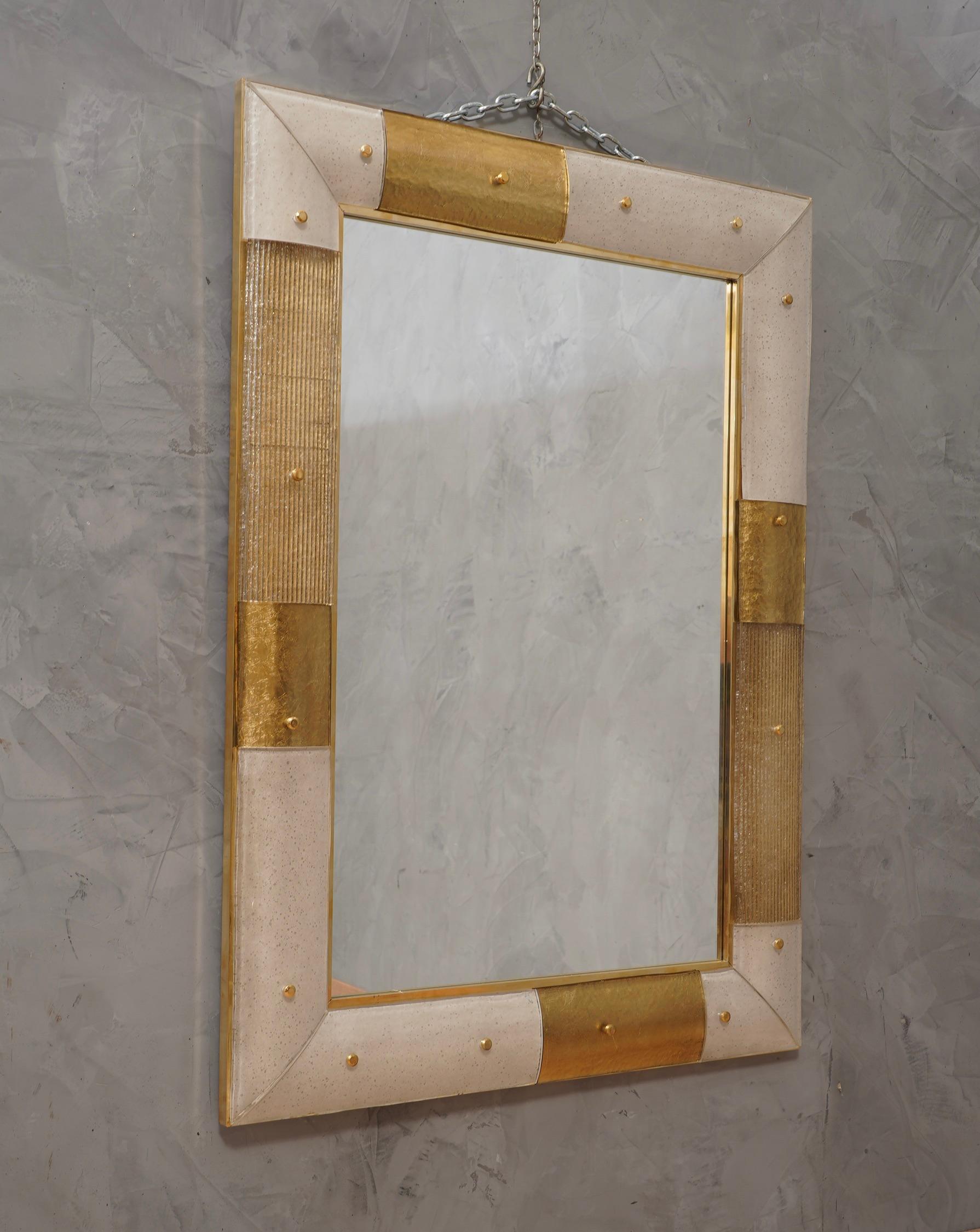 A strong white and gold frame reach the eye of the beholder leaving him entranced; of Murano gold and white art glass wall mirror. 

The structure of the wall mirror is in wood, where the gold and white Murano glass is housed. The frame of the
