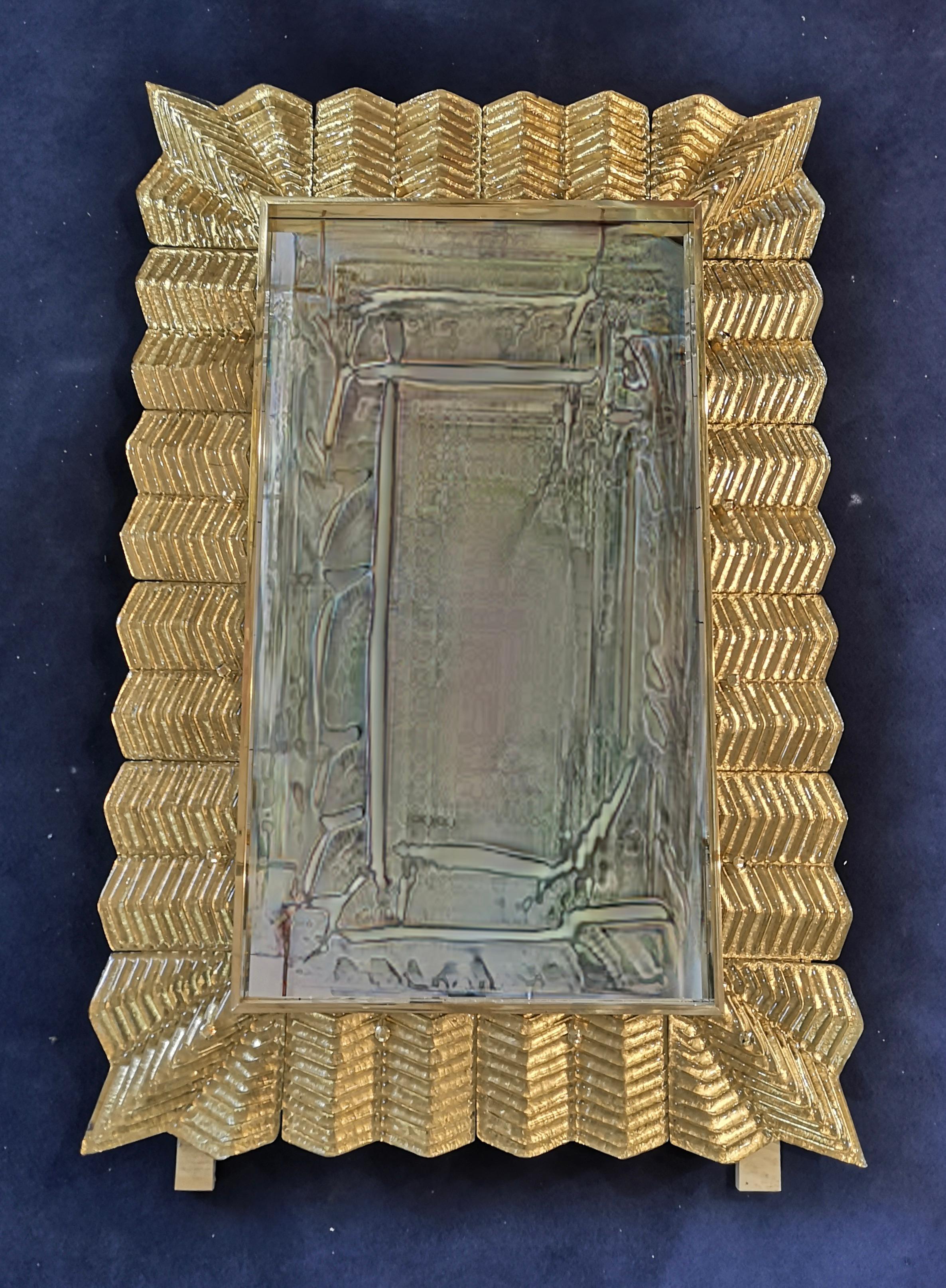 A strong gold color frame, reach the eye of the beholder, leaving him entranced; of Murano gold art glass wall mirror. Beautifully shaped and of excellent size, the wall mirror is a real design object.

The structure of the wall mirror is in wood,