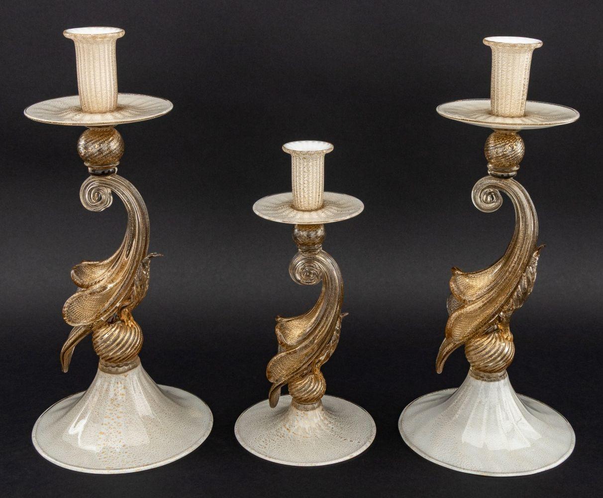 Group of Three Murano Gold-Flecked Glass Graduated Candlesticks, each with fluted drip pan above floriform stem atop circular base. Tallest: 14.25