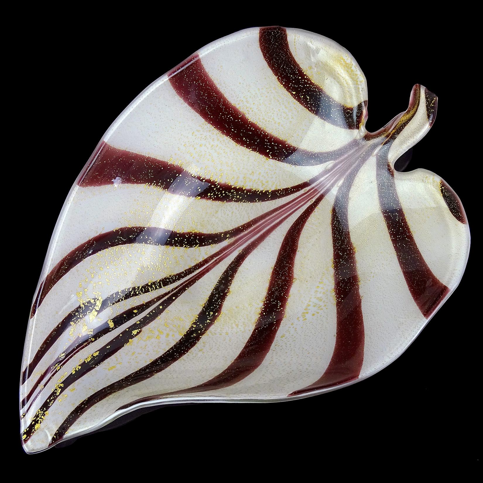 Beautiful vintage Murano hand blown dark wine purple stripes and gold flecks Italian art glass leaf shaped bowl. The bowl is a large size, with feathered design and profusely covered in gold leaf. Would make a great display piece on any table. It
