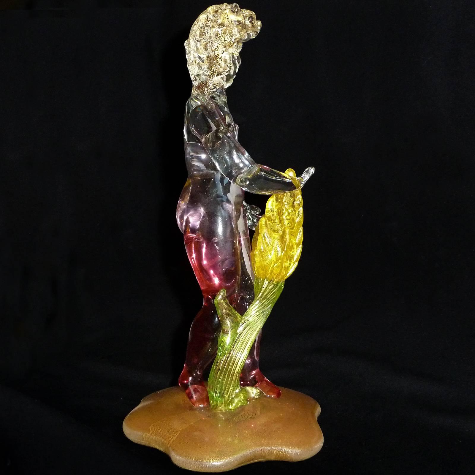 Beautiful vintage Murano hand blown pink Sommerso nude garden nymph Italian art glass sculpture, tending to a yellow and gold flecks flower. The figure also has gold leaf on her hair, and very heavy gold on the base. Can be used as a display piece