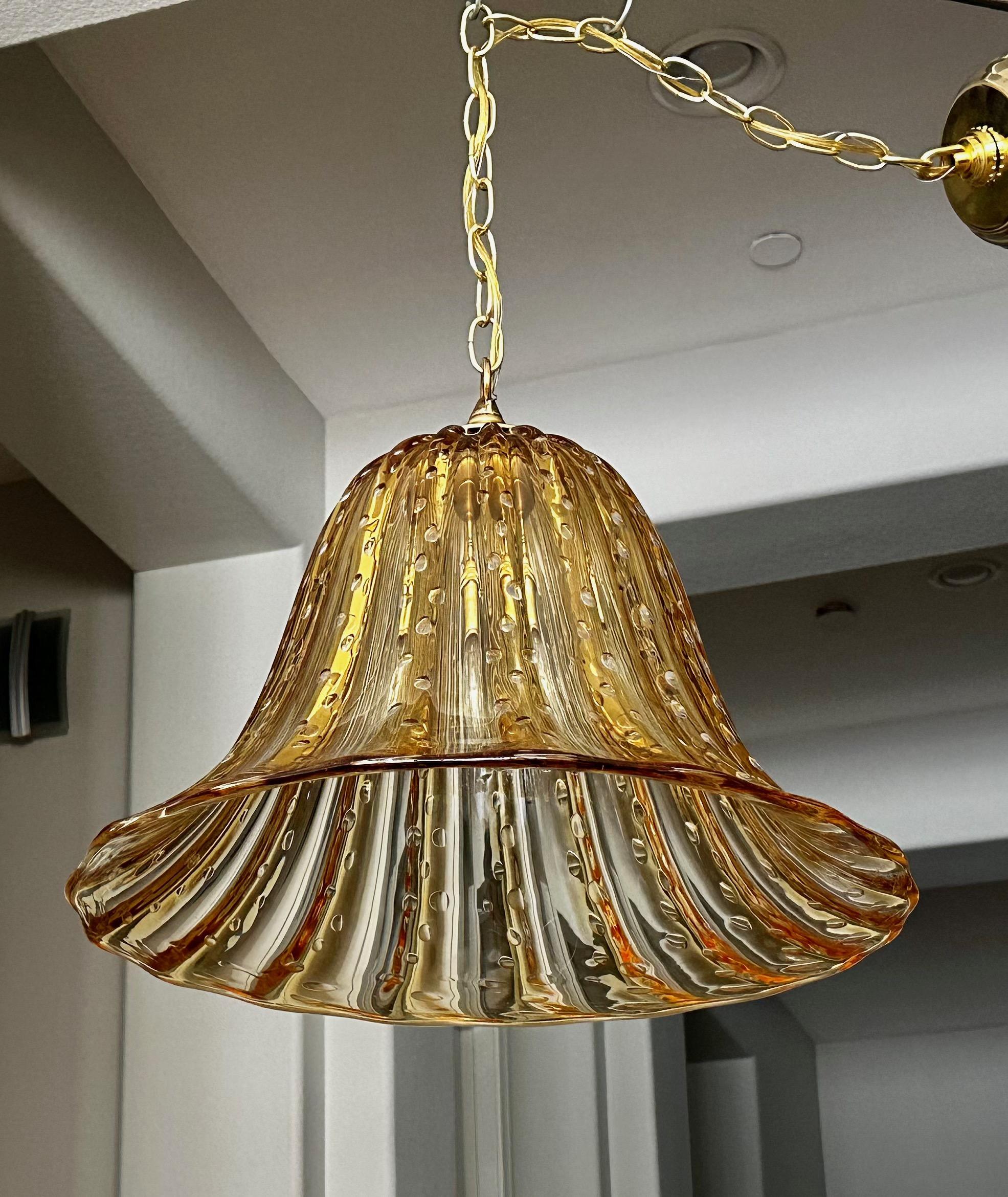 Murano Italian bell shape gold amber colored hand blown glass pendant ceiling light. The glass has vertical ribbing along with rows of controlled bubbles. Attributed to Barovier & Toso. Fixture uses regular A base bulb. Newly wired. Perfect for