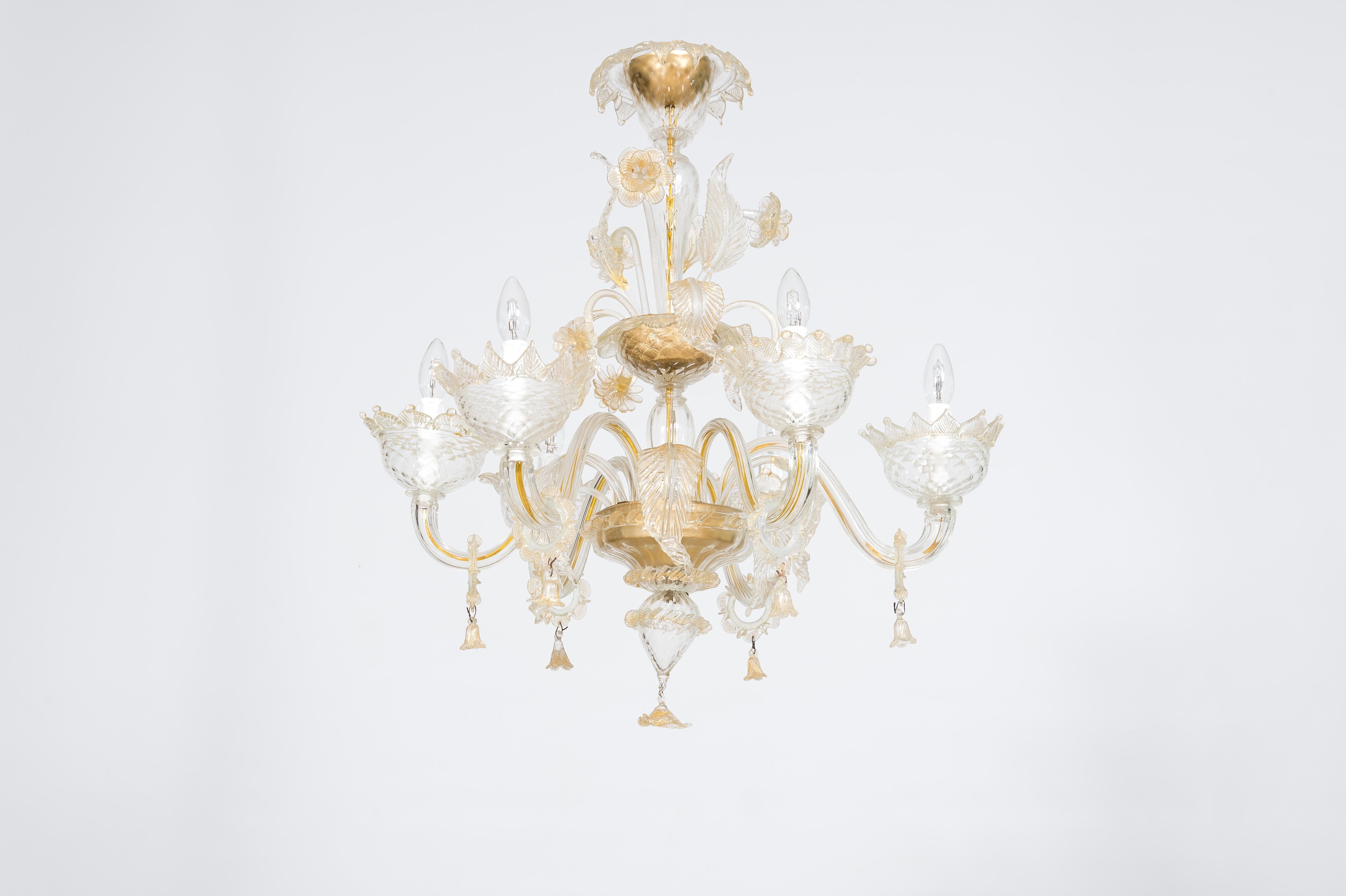 This exquisite Murano glass chandelier, a testament to Italian craftsmanship, was masterfully created in the 1980s by the renowned Vintage Murano Gallery. Adorned with delicate gold accents, this captivating piece embodies timeless elegance and