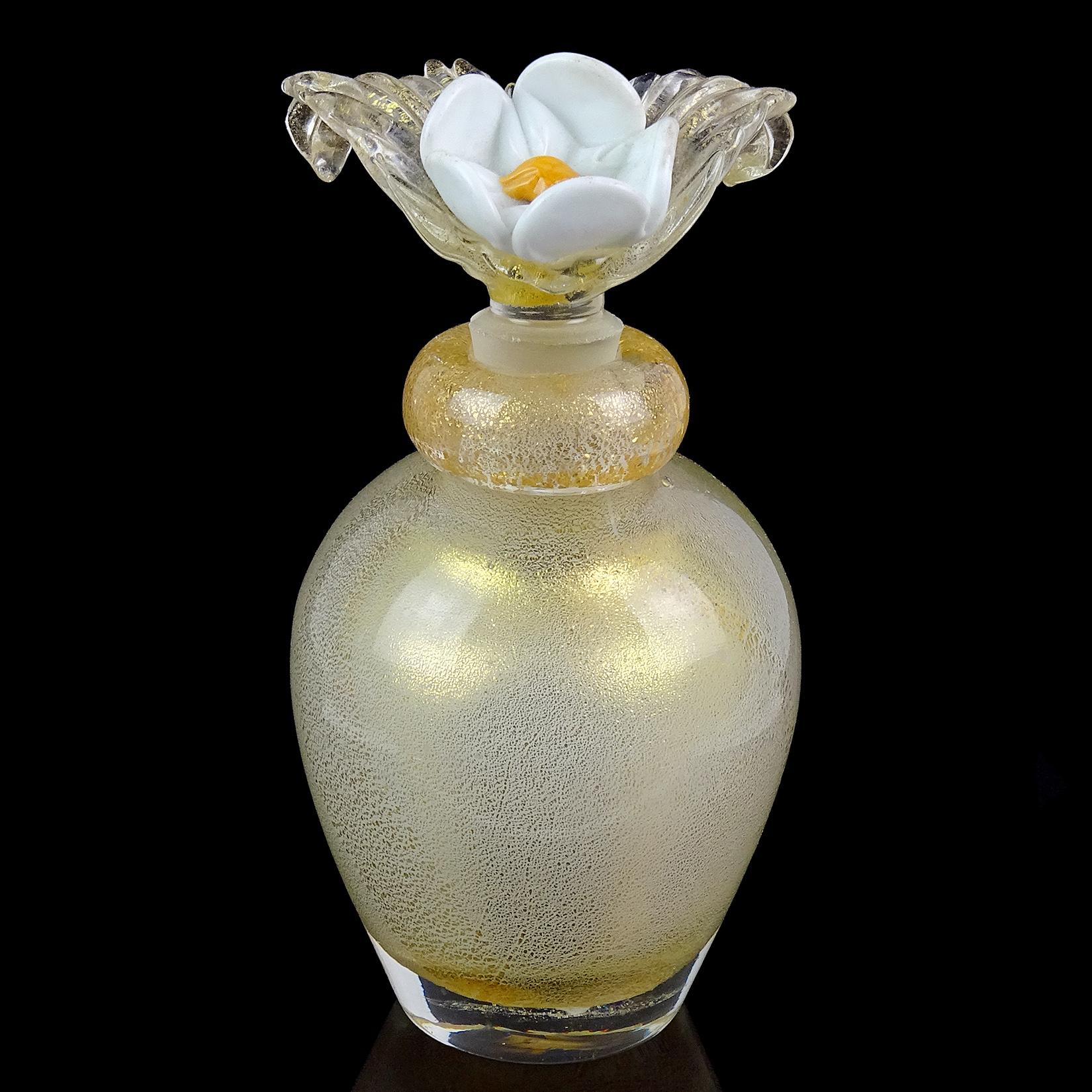 Gorgeous vintage Murano hand blown gold flecks over white Italian art glass perfume bottle. Attributed to designer Archimede Seguso. The bottle has a beautiful large flower stopper, in white with bright orange center and clear leafs with gold. The