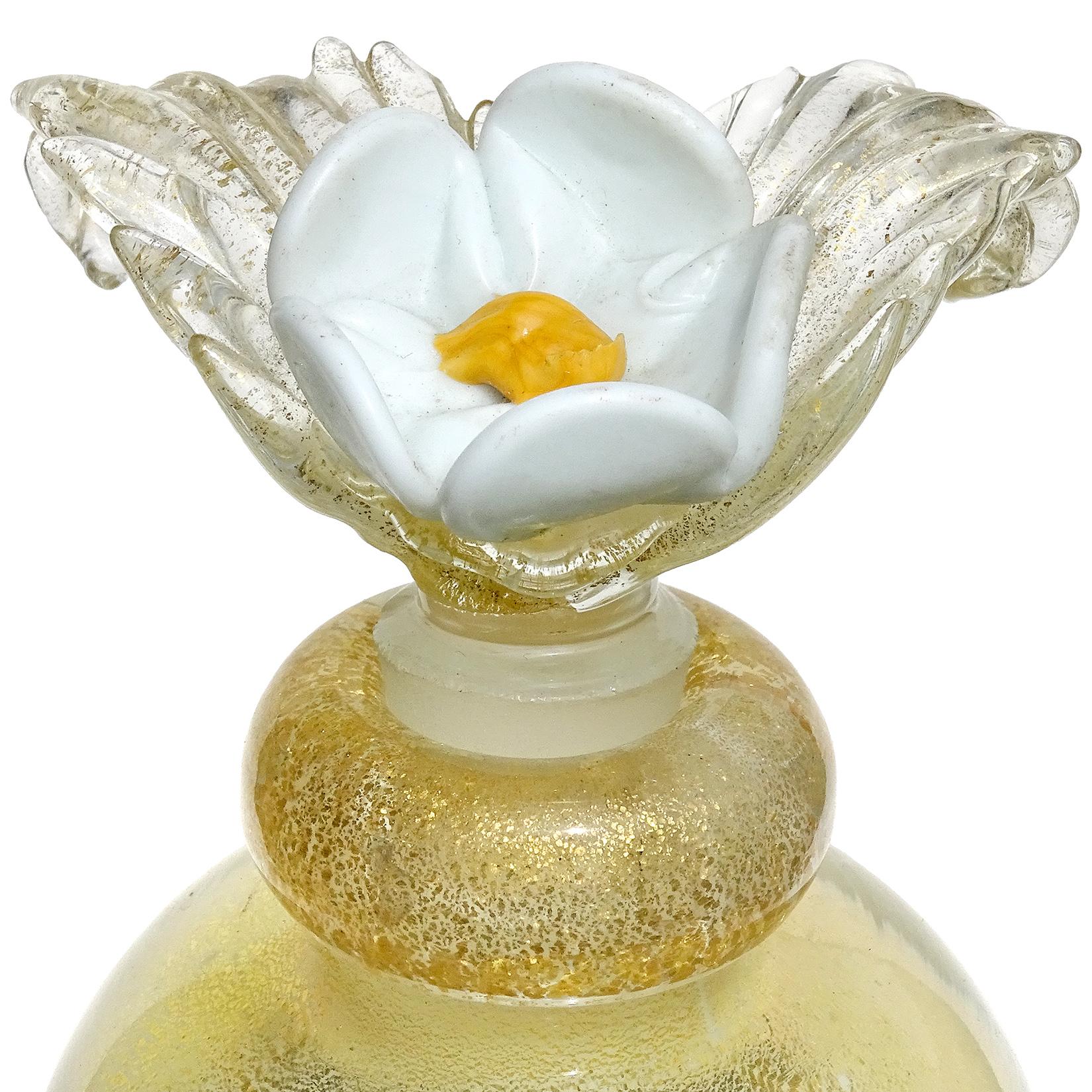 perfume bottle with white flower on top