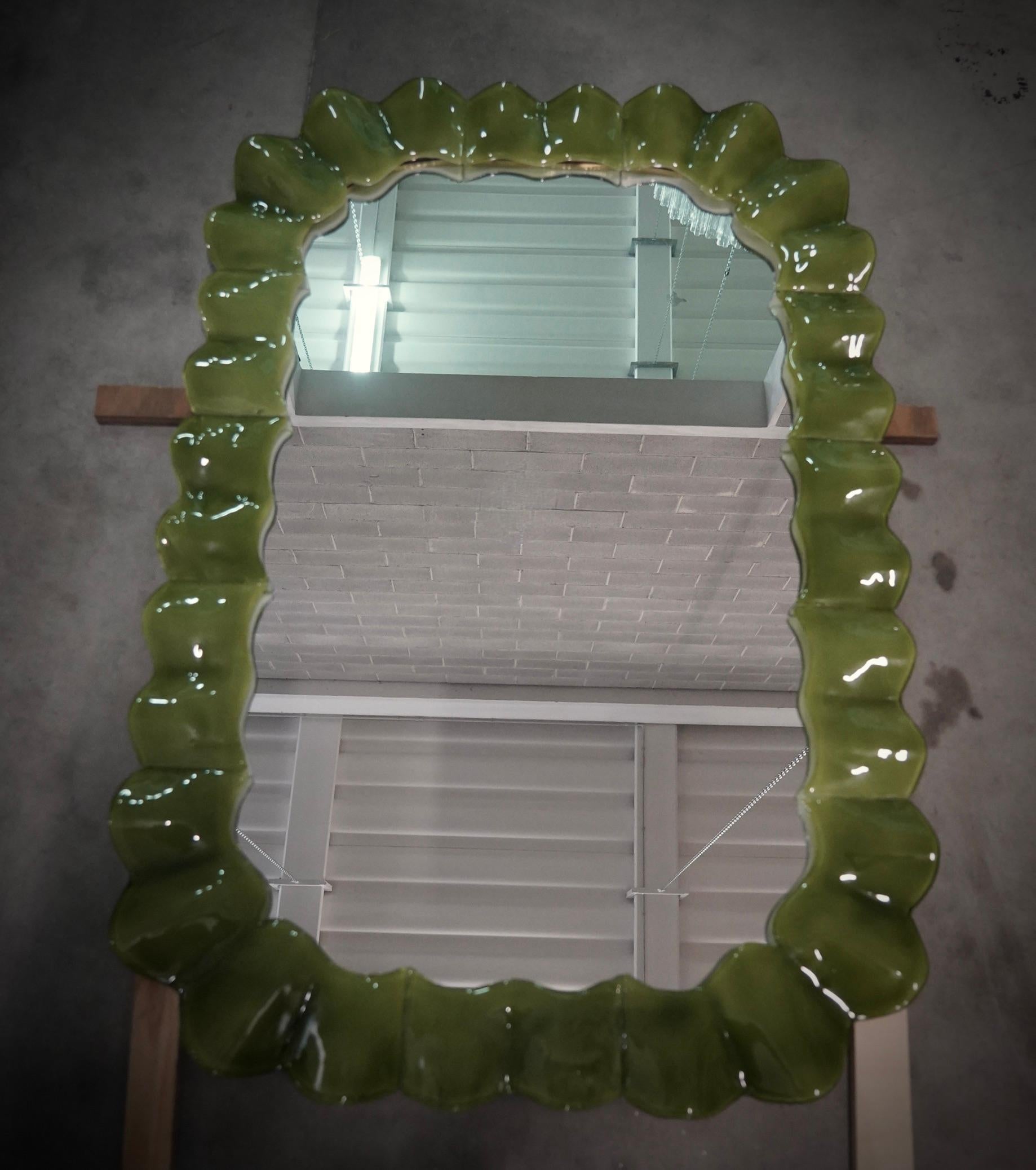 Splendid bright green Murano glass mirror. A mirror that alone will furnish your home environment. Rich but tasteful, the mirror has a truly particular design, with a very beautiful shape of these glass sections.

The mirror has a wooden rear