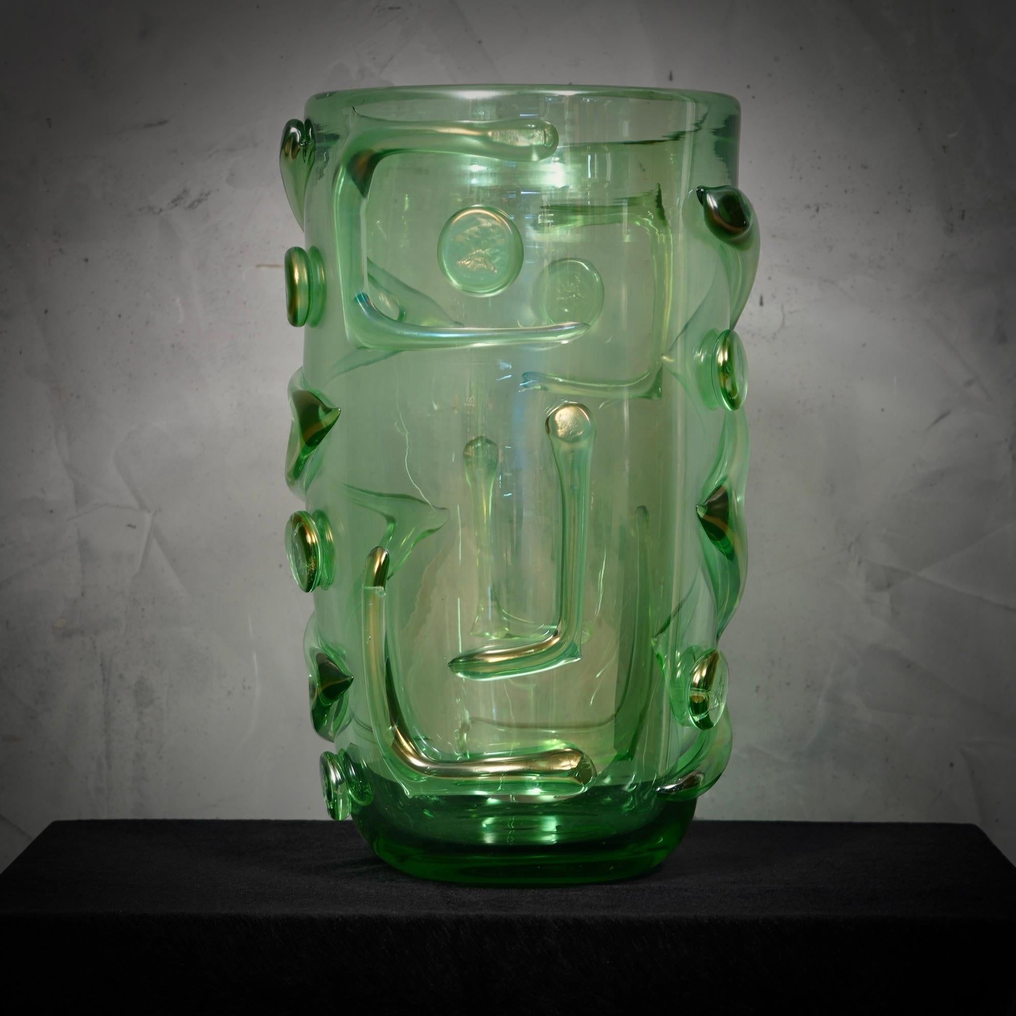 Splendid Murano glass vase in marine green color. Note the beautiful hot-attached castings. A supreme artistic manufacture. In this factory you can feel all the Venetian flavor.

The vase is composed of a large upper cup, onto which glass fusions of