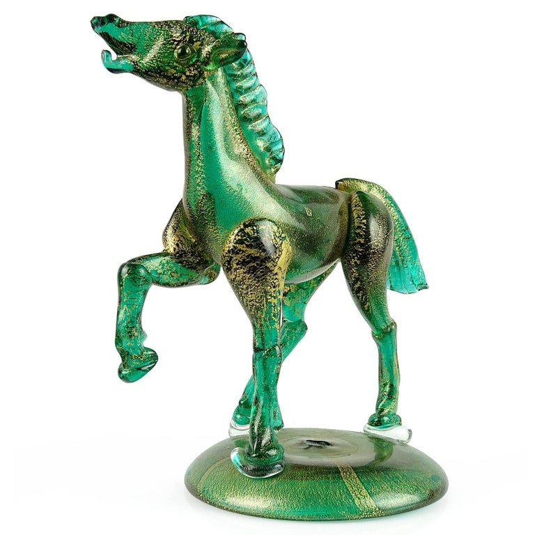 Elegant antique Murano hand blown green and gold flecks Italian art glass horse sculpture on base. Highly detailed, with a great galloping stance and expression. Profusely covered in heavy gold leaf. Created in the manner of high end glass workshops