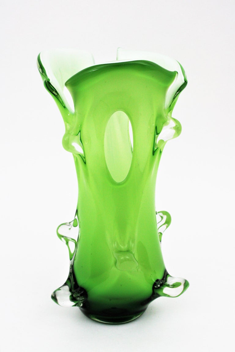 Mid-Century Modern green and white Murano Art glass Forato vase with pulled details. Italy, 1950s.
Monumental Mid-Century Modern organic shaped green Murano glass Forato ( hole) large flower vase.
Manufactured in a gradient of green glass at the