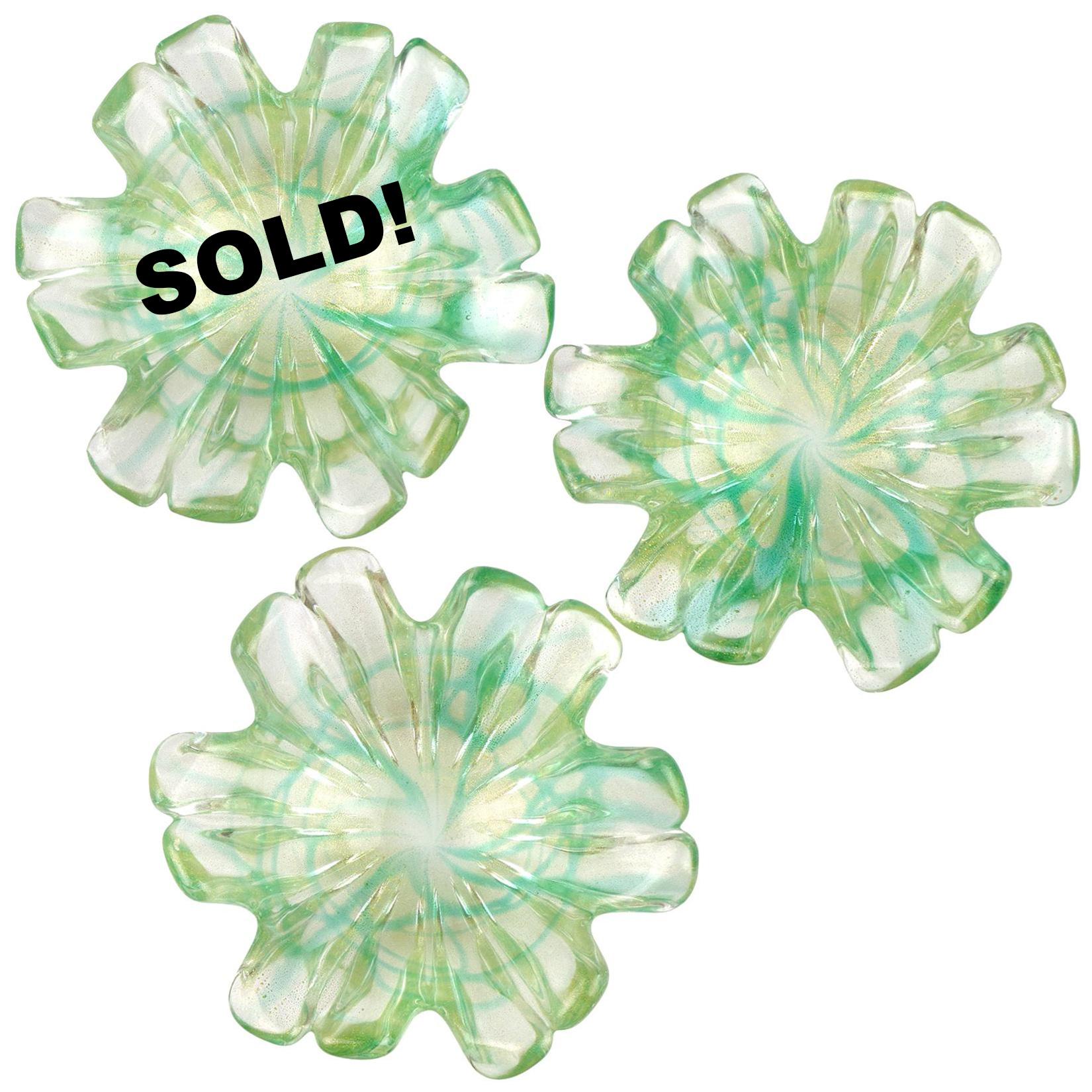 Price per item (Only 2 left). Beautiful vintage Murano hand blown green spatter swirl and gold flecks Italian art glass flower shaped bowls. The bowls are profusely covered in gold leaf. Each has its unique swirl design. Would make a great display