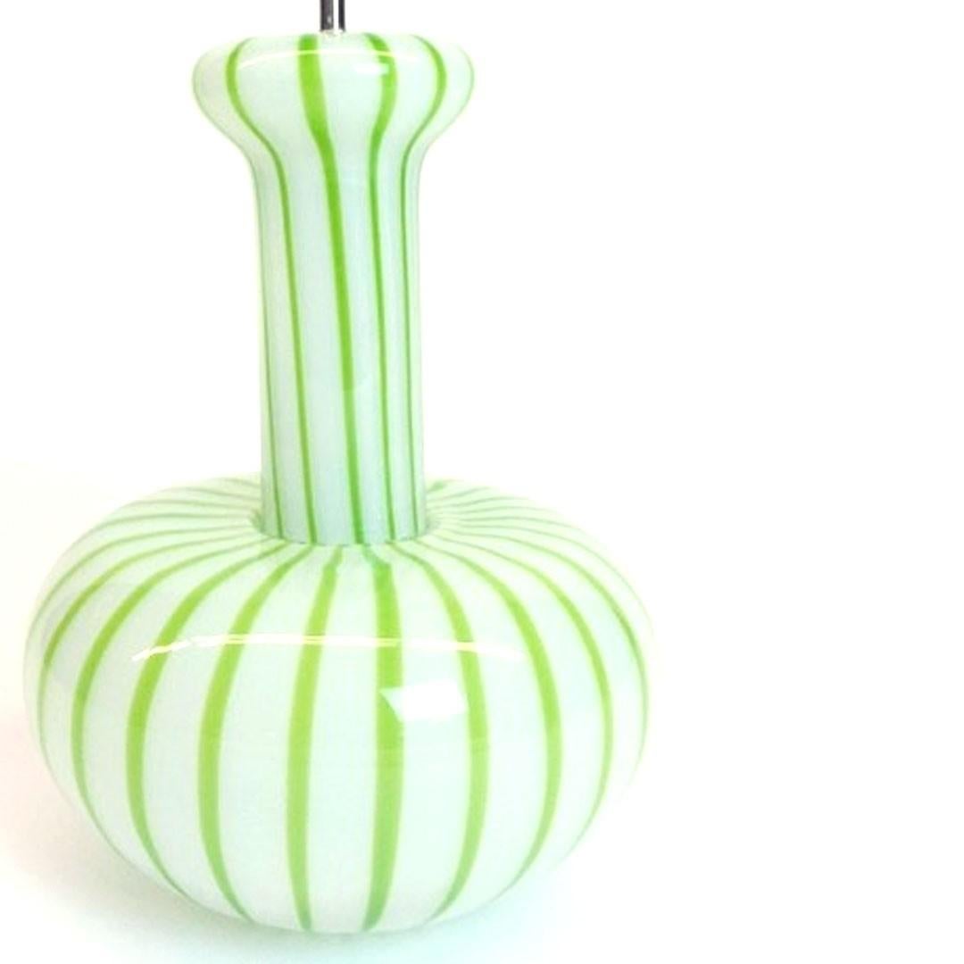 A Murano glass pendant light fixture with a green and white swirl pattern. Italy, circa 1960. Includes chrome stem and canopy.