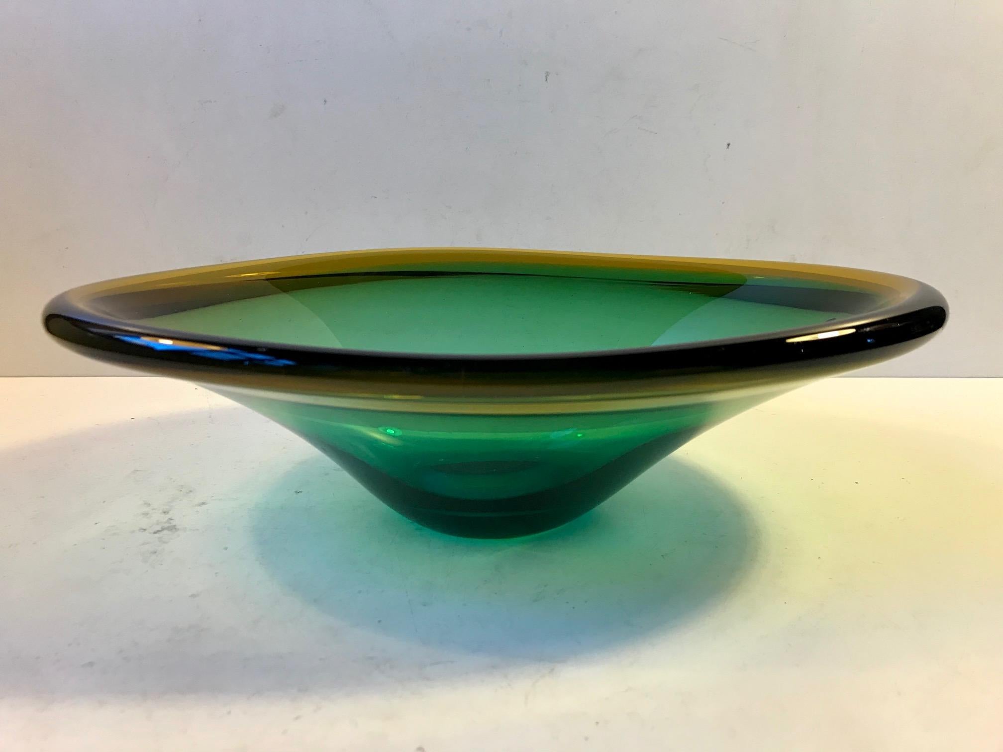 Hand blown art glass bowl in an ovoid shape. It’s made from cased green and yellow glass. It was designed by Flavio Poli during the 1960s and manufactured at Seguso in Murano, Italy.