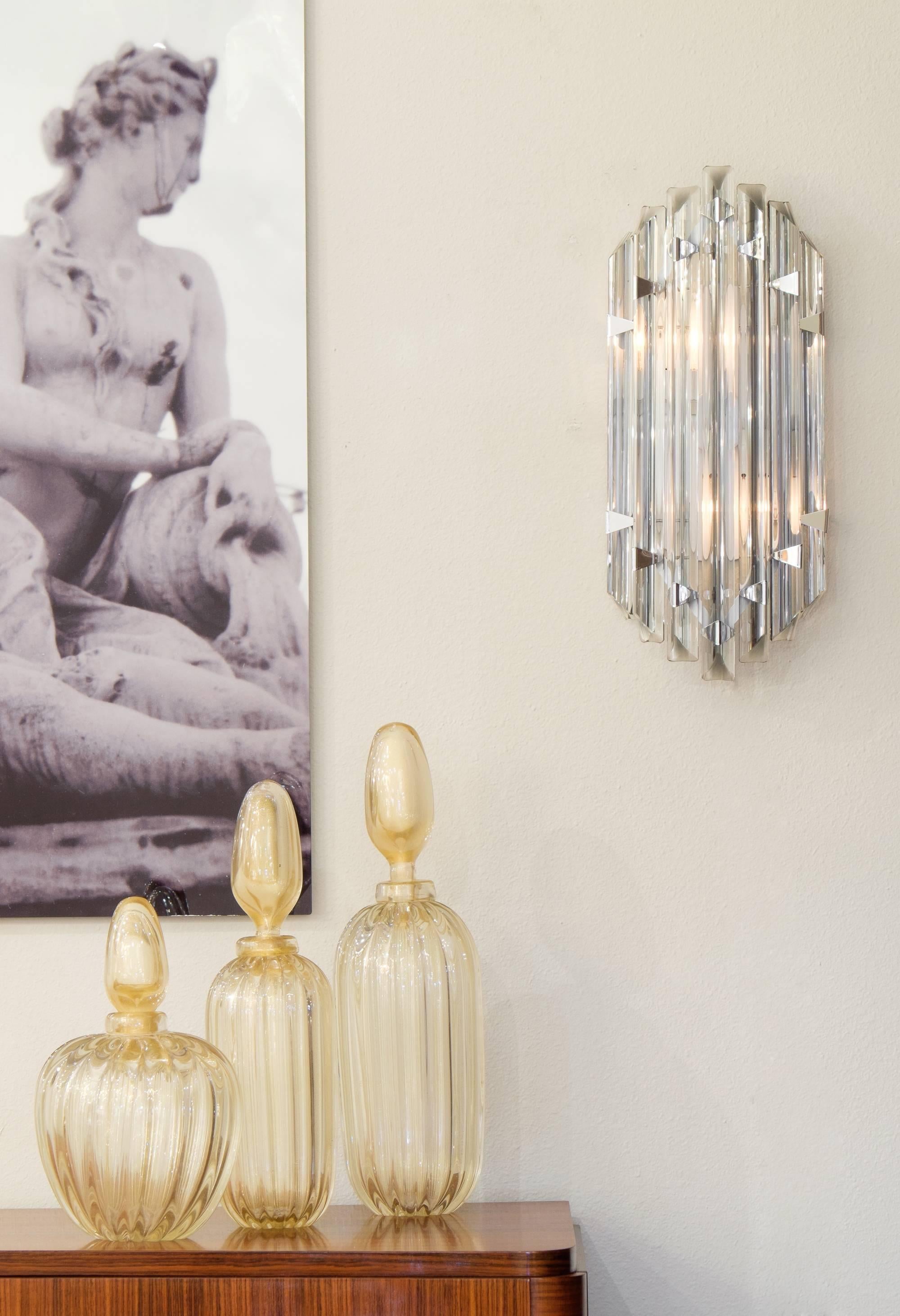 A diamond bright pair of Murano grey glass sconces in the style of Venini. This glittering pair of large flush mount sconces feature seven long prism 