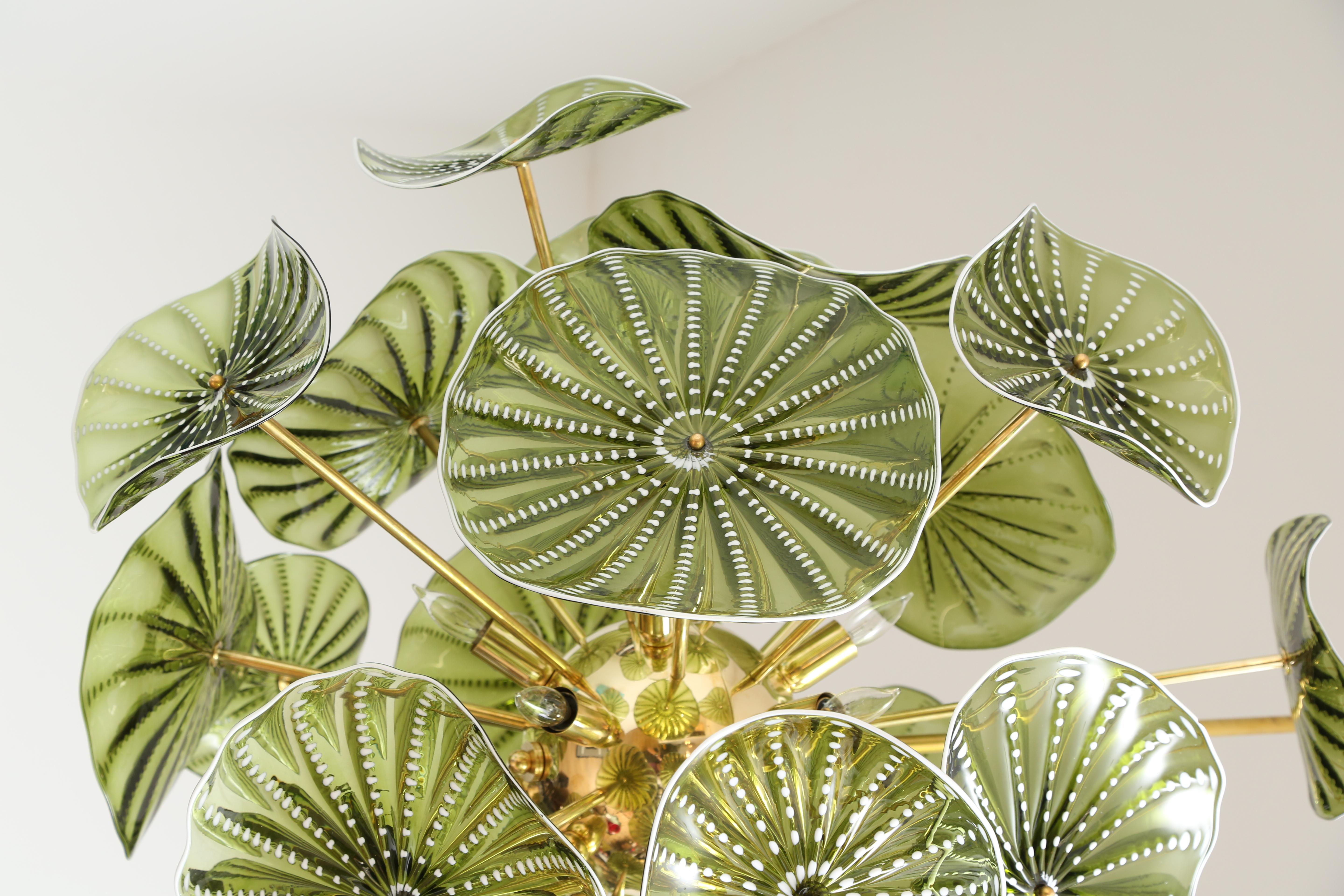 Murano hand blown studio glass chandelier. 
All different shaped chartreuse green discs with white details.
Brass plated structure with 24 exposed brass regular sockets.
Drop can be adjusted to your own specification
Located in our showroom in