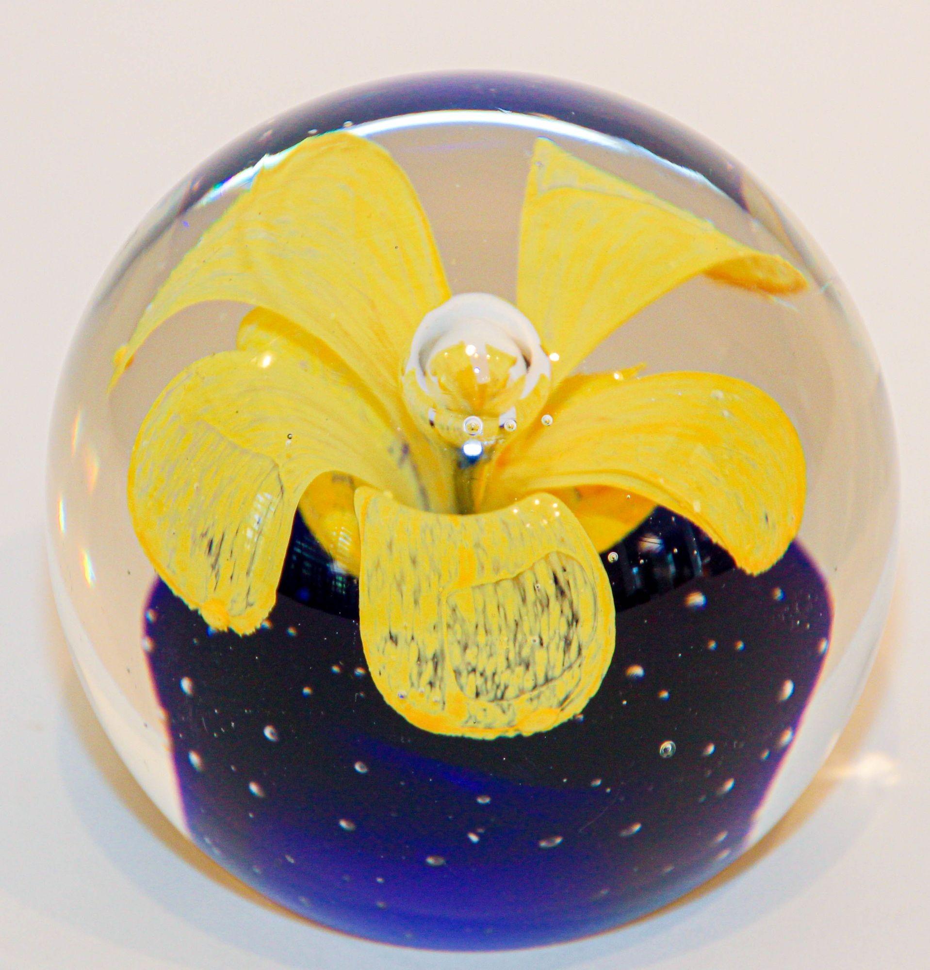 Vintage Murano Hand Blown Paperweight Yellow Flower with Blue Collectible Art Glass.
Beautiful heavy large glass paperweight featuring yellow in a blue base flower blown design inside, has flat bottom.
Art glass paperweight featuring a large
