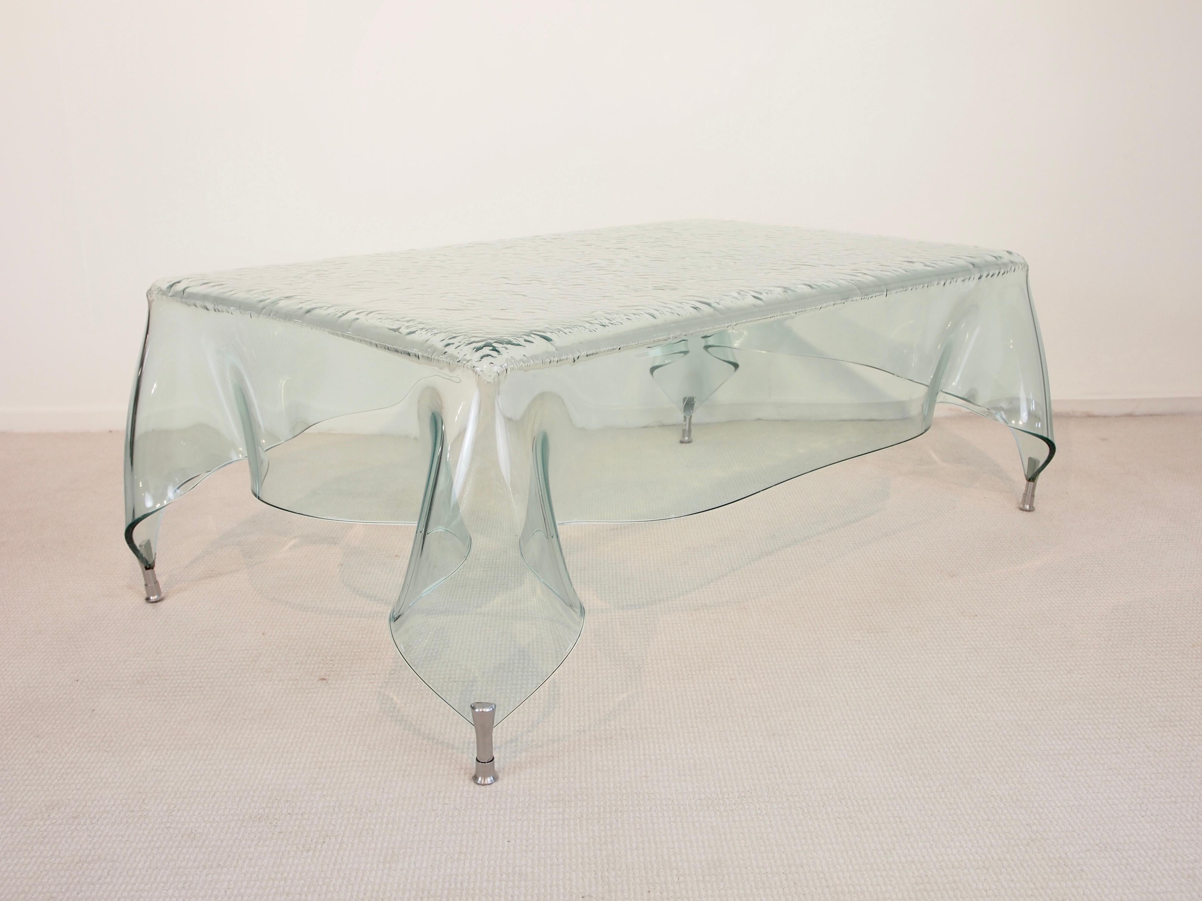 Magnificent glass-art piece with a hand blown glass top in the shape of a handkerchief. 

Together with the extra ordinary shape of the coffee table the bubbles pattern inside the top of the table gives this table its marvelous stunning