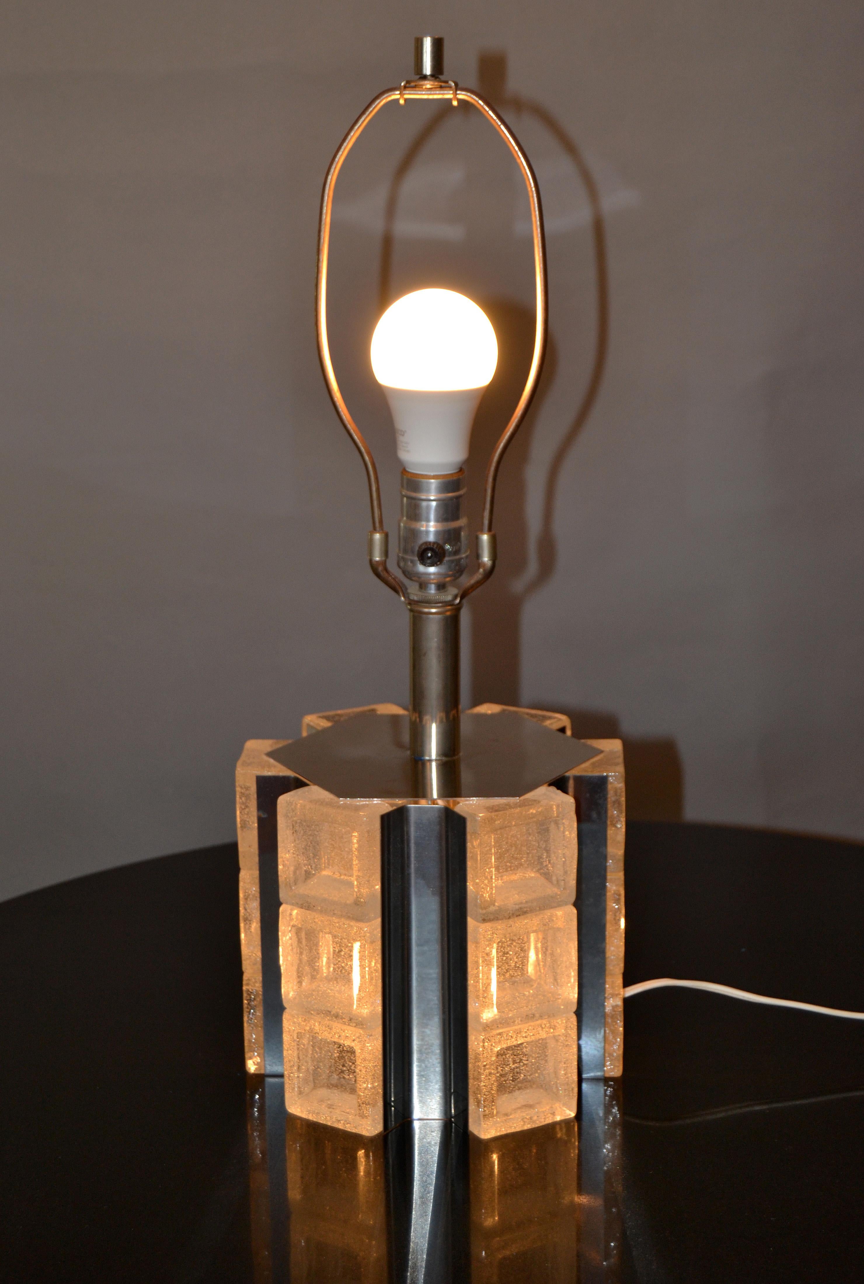 Mid-Century Modern octagonal Murano ice glass and chrome table lamp by Mazzega.
It is wired for the U.S. and takes 2 light bulbs, one regular 60 watts and a 25 watts inside the core.
No shade included.