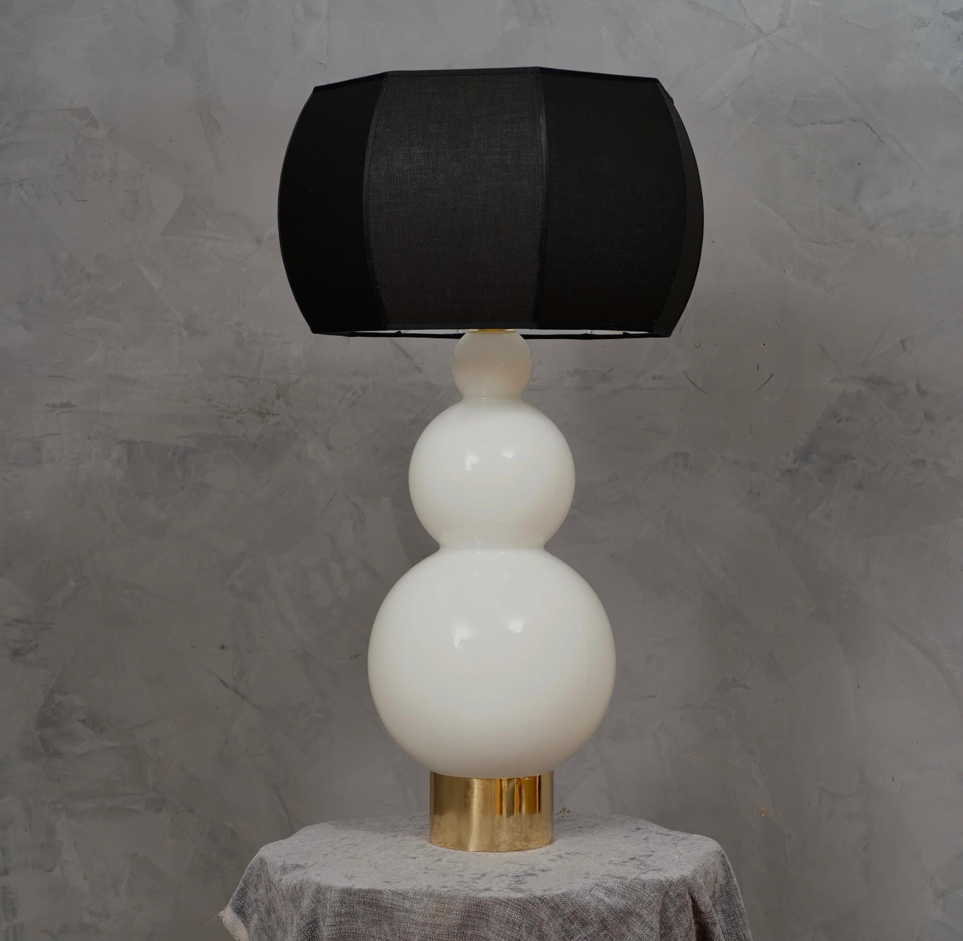 Precious and unique hand-blown Murano white glass, classic but original design with a strong contrast between the white of the glass and the black of its lampshade.

The lamp is composed of a rich cylindrical brass base on which the glass with its