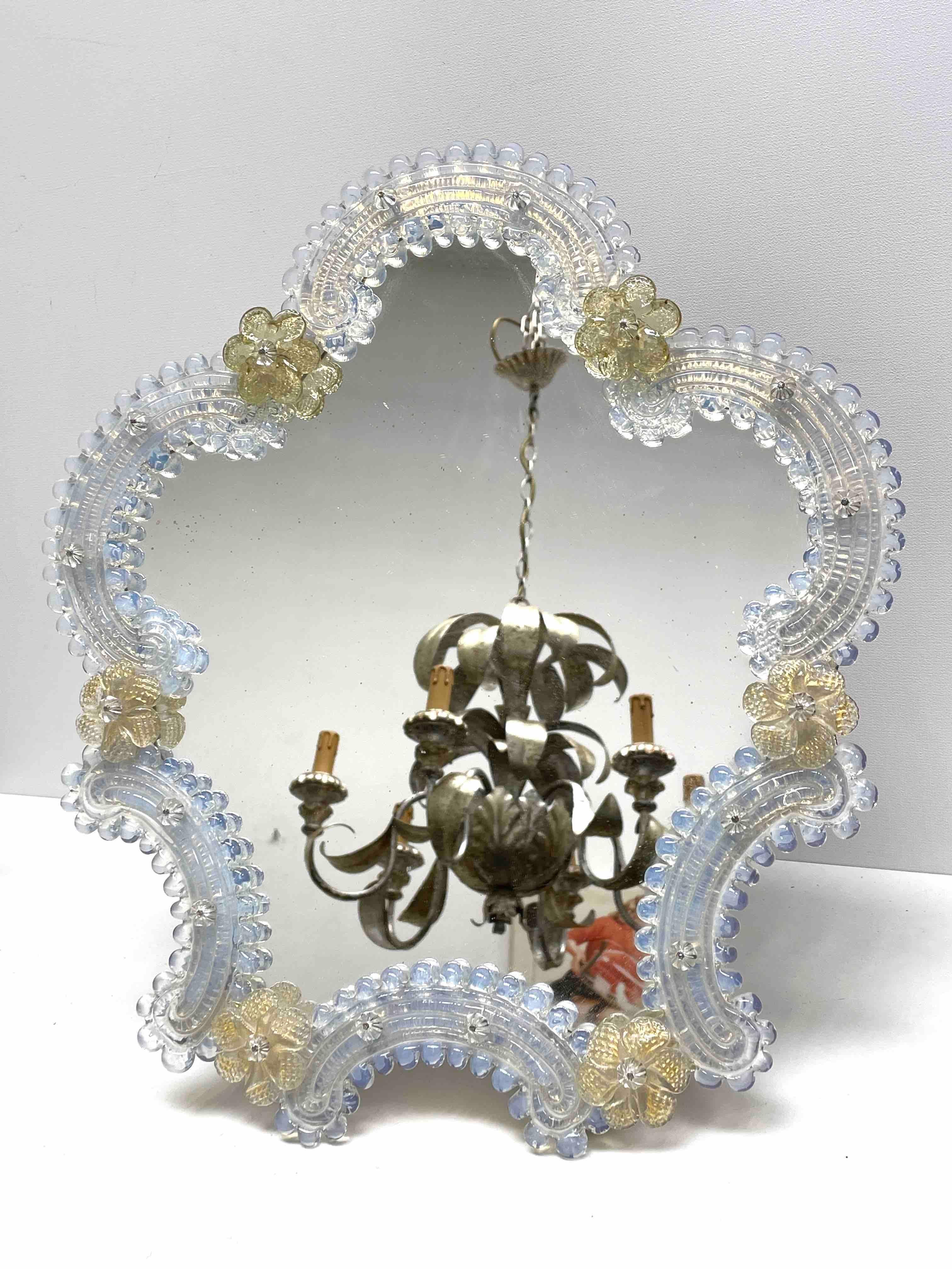 A gorgeous Murano glass vanity mirror surrounded with handmade glass flowers. With minor signs of wear as expected with age and use. A nice addition to any dressing room.