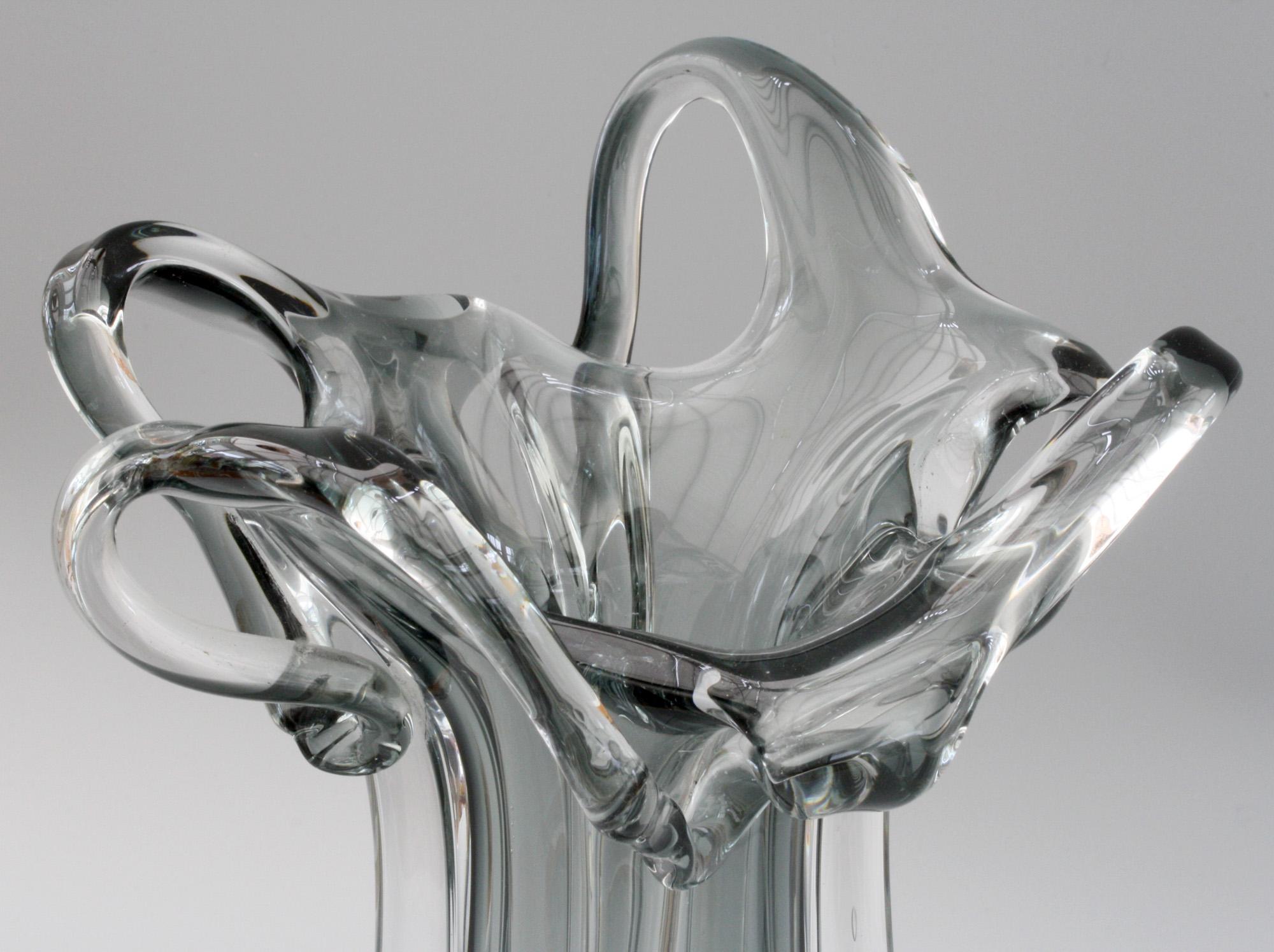 A stunning Italian Murano grey cased sculptural art glass vase dating from 1950-1970. This heavily made hand blown vase is made in clear glass with an encased grey glass centre the slender body with four wing like applications with extend to the top