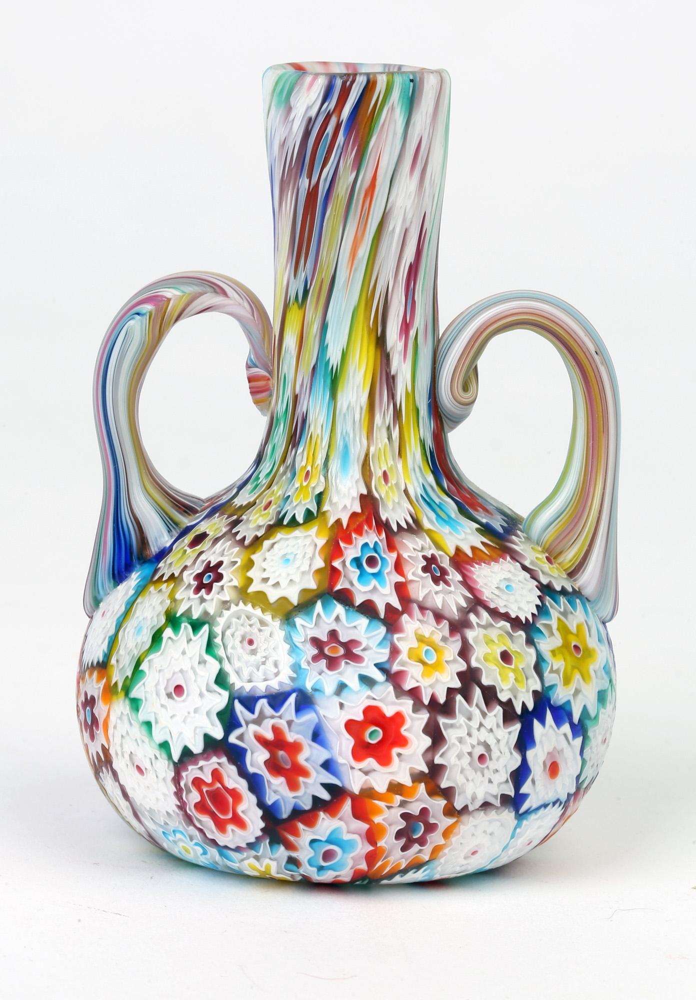 A very fine Art Deco Italian Murano satin glass millefiori twin handled vase dating from circa 1930-1940. This quality vase is of small bottle shape with a rounded bulbous body and tall slender neck with loop handles applied to either side of the
